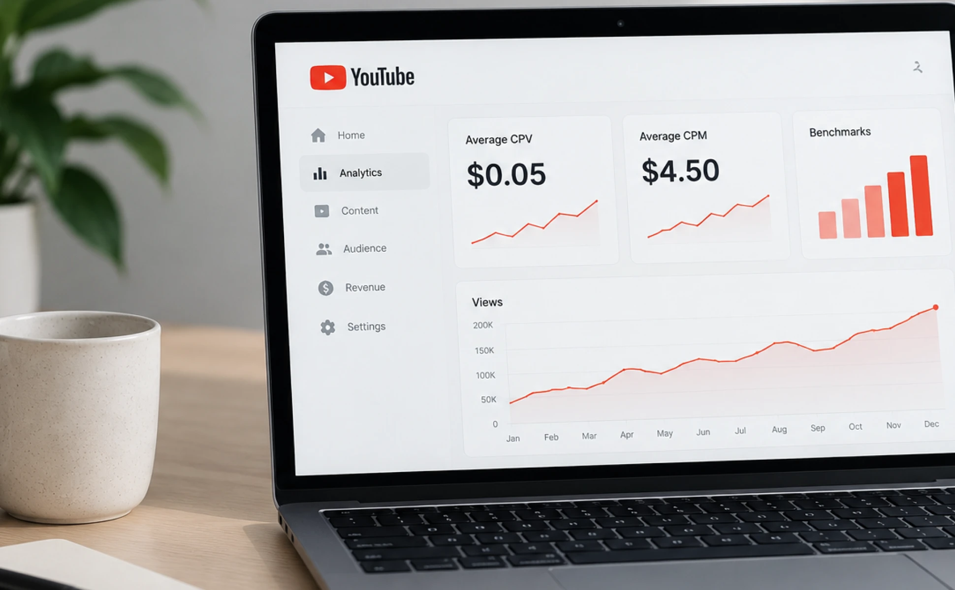 Laptop showing a YouTube analytics dashboard with metrics and growth charts on a wooden desk.