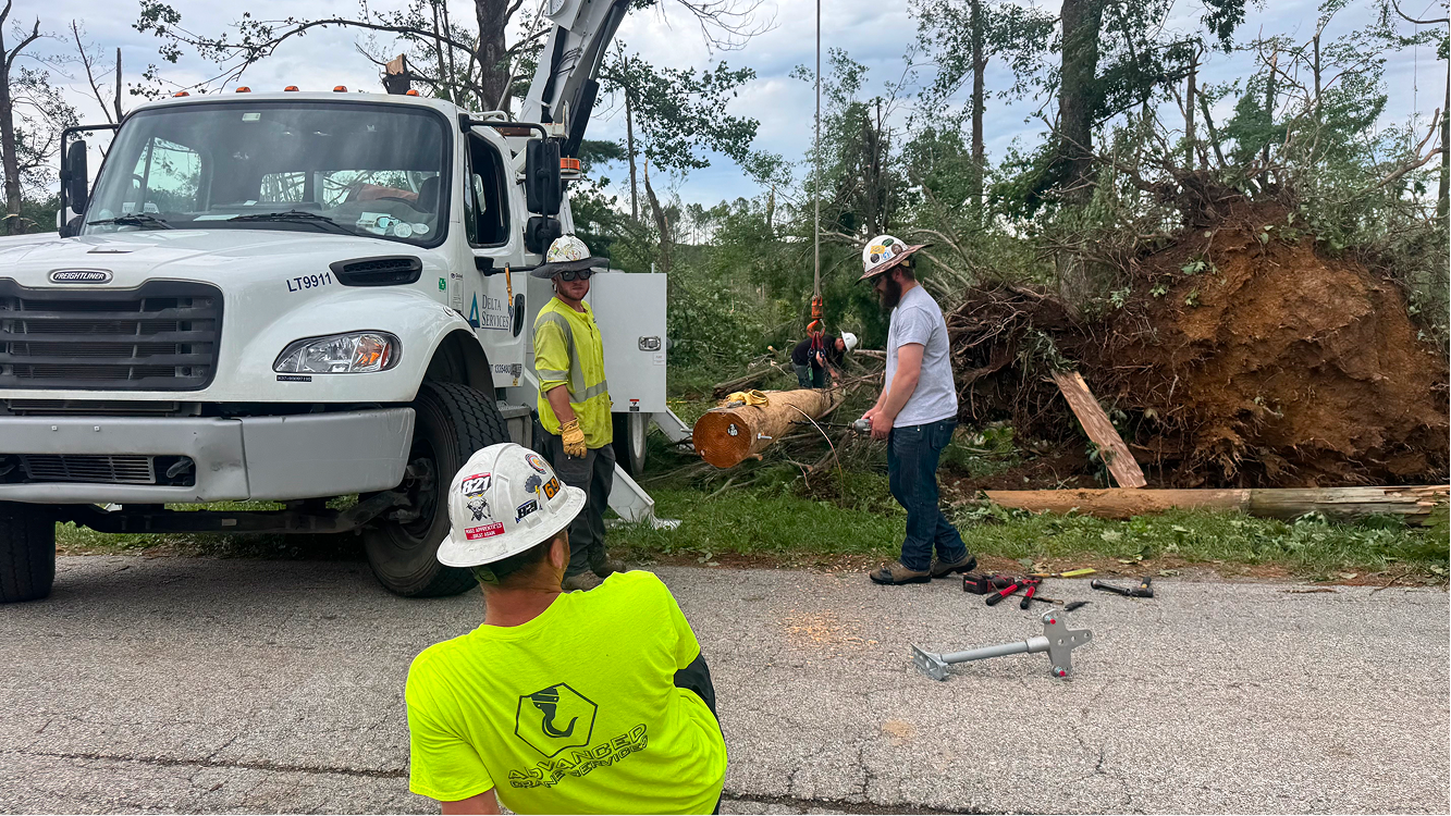 A crew works on the tornado damaged area on June 18 on Buskirk Road in rural Gosport. Several utility vehicles lined the street that afternoon. CHLOE ODEN | THE OWEN NEWS