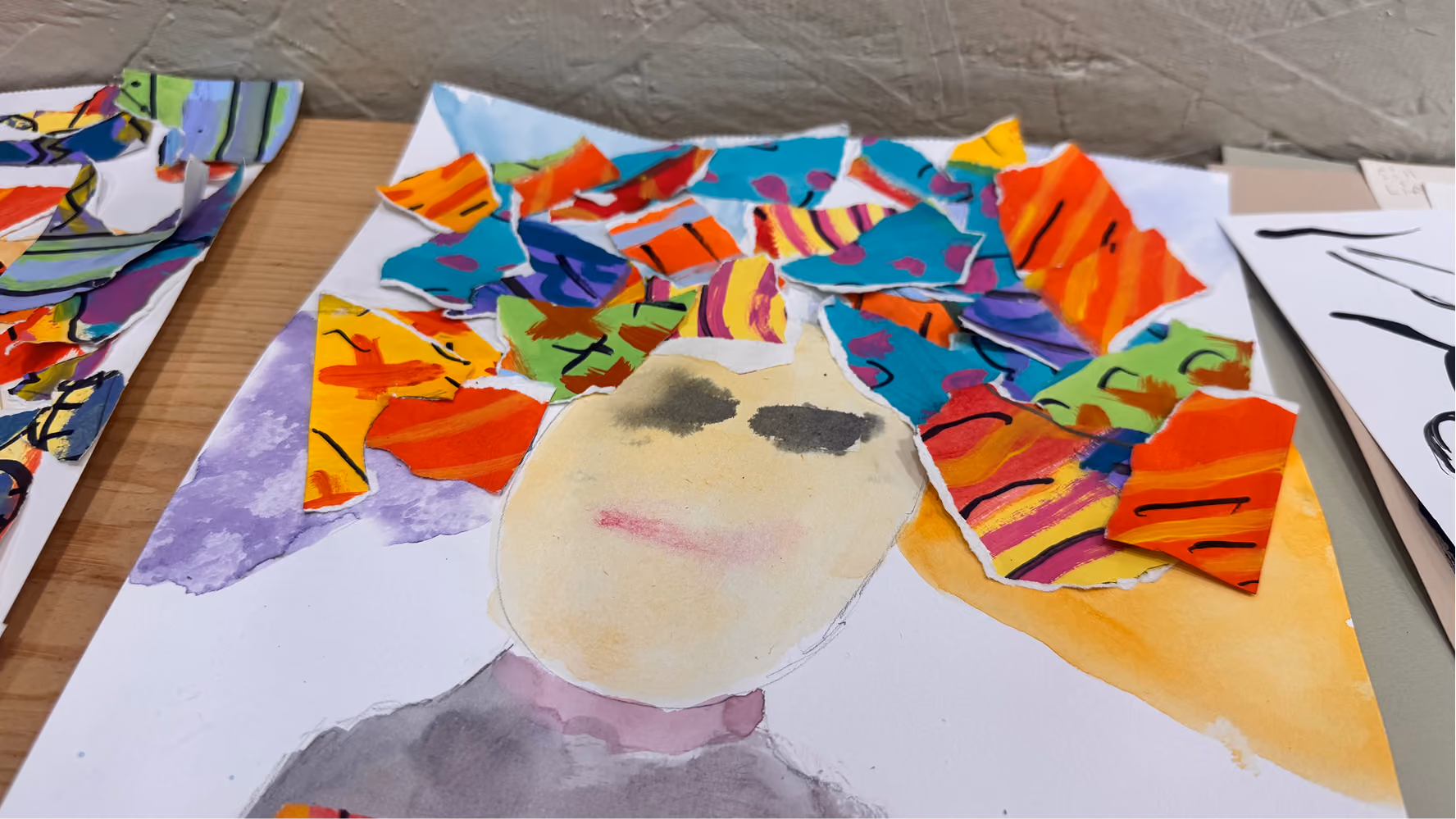 A camper's collage art is displayed on June 11 at the Owen County Art Guild. The collages combined watercolor and ripped pieces of paper.