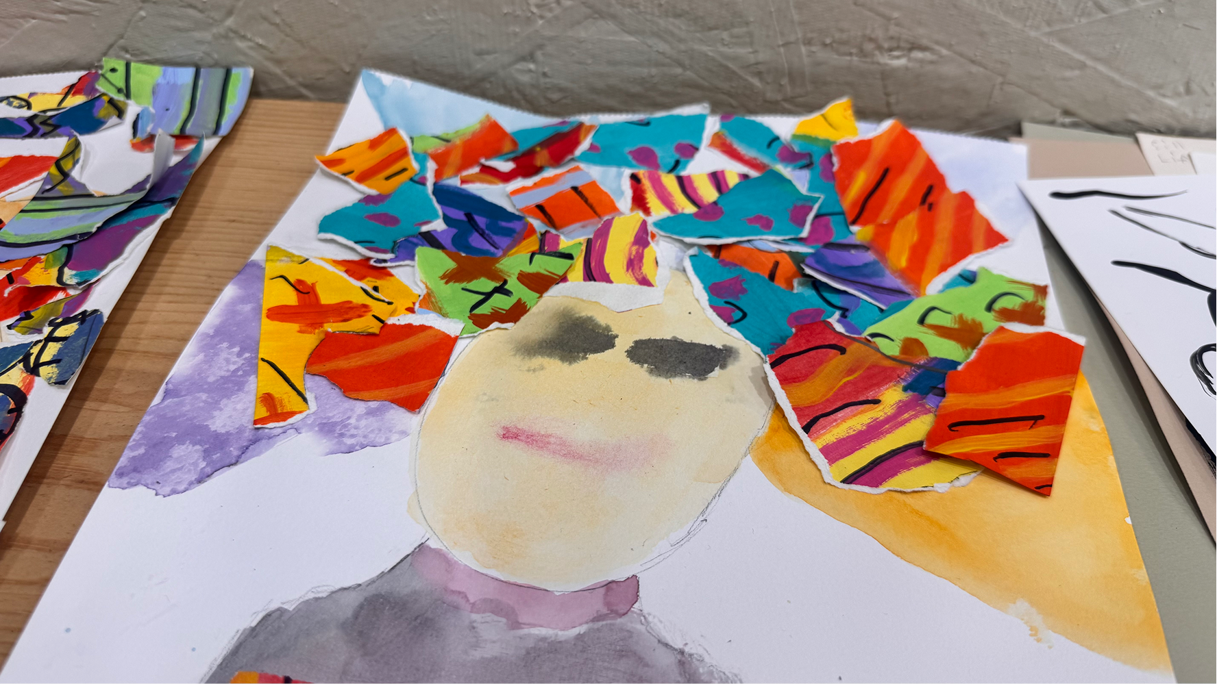 A camper's collage art is displayed on June 11 at the Owen County Art Guild. The collages combined watercolor and ripped pieces of paper.