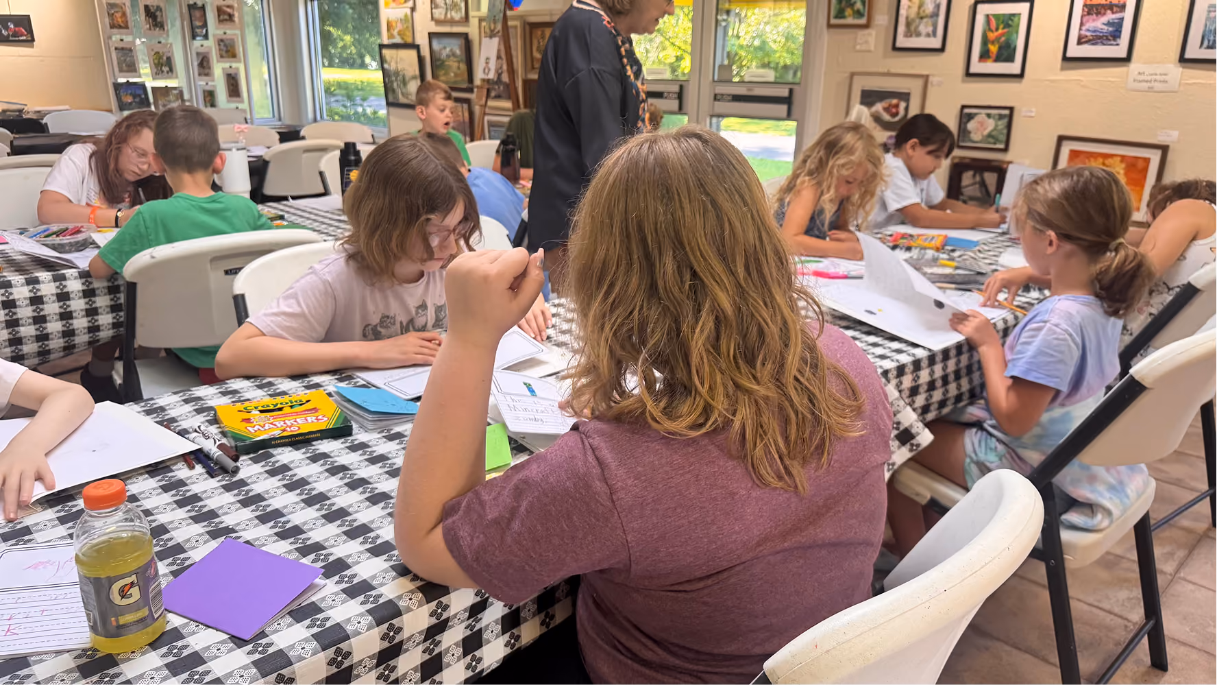 Felicity Arthur (back) and Amelia Borders (front) work on their children's books on June 11 at the Owen County Art Guild. Creating children's books was a new addition to the program this year.