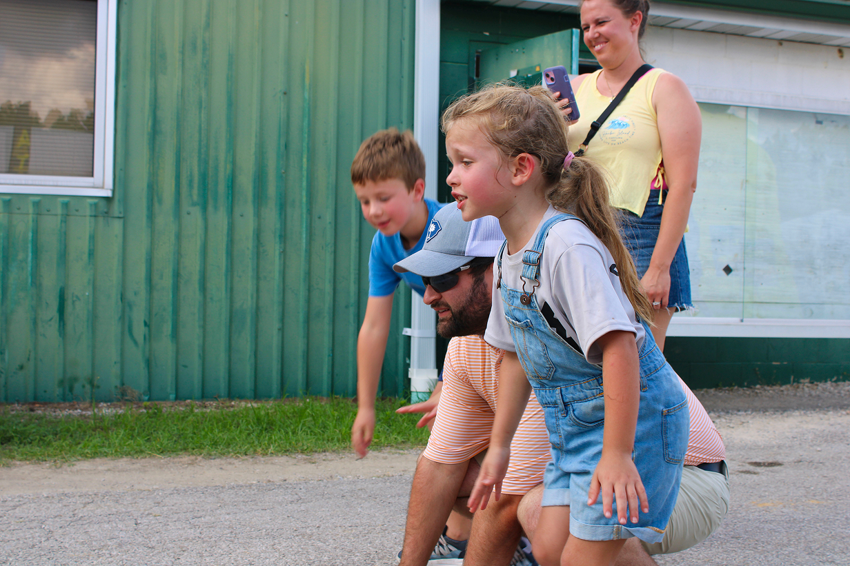 Owen County Fair attendees cheer on participants in the Kiddie Tractor Pull on July 10 outside the Exhibit Hall at the fairgrounds. CHLOE ODEN | THE OWEN NEWS