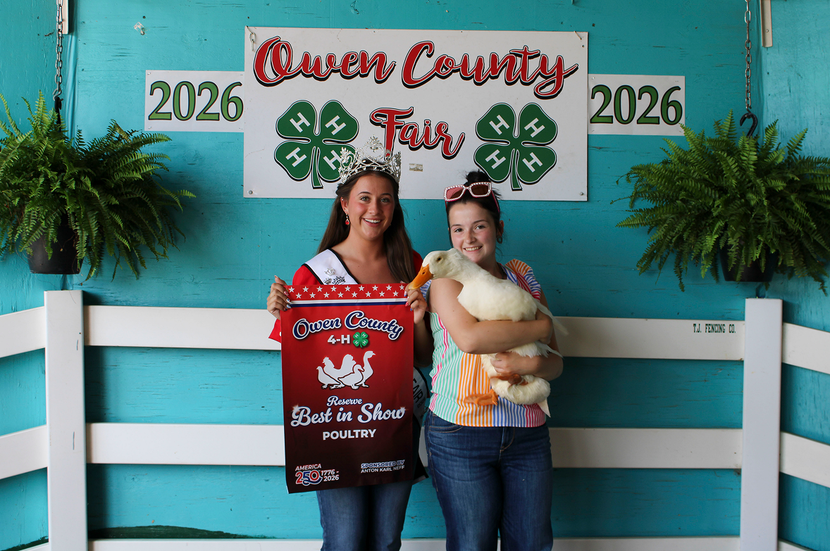 From left, 2026 Miss Owen County Makayla Hall poses next to Ily Swan, who holds her Reserve Grand Champion goose in the Poultry Show on July 8 at the Owen County Fairgrounds. CHLOE ODEN | THE OWEN NEWS
