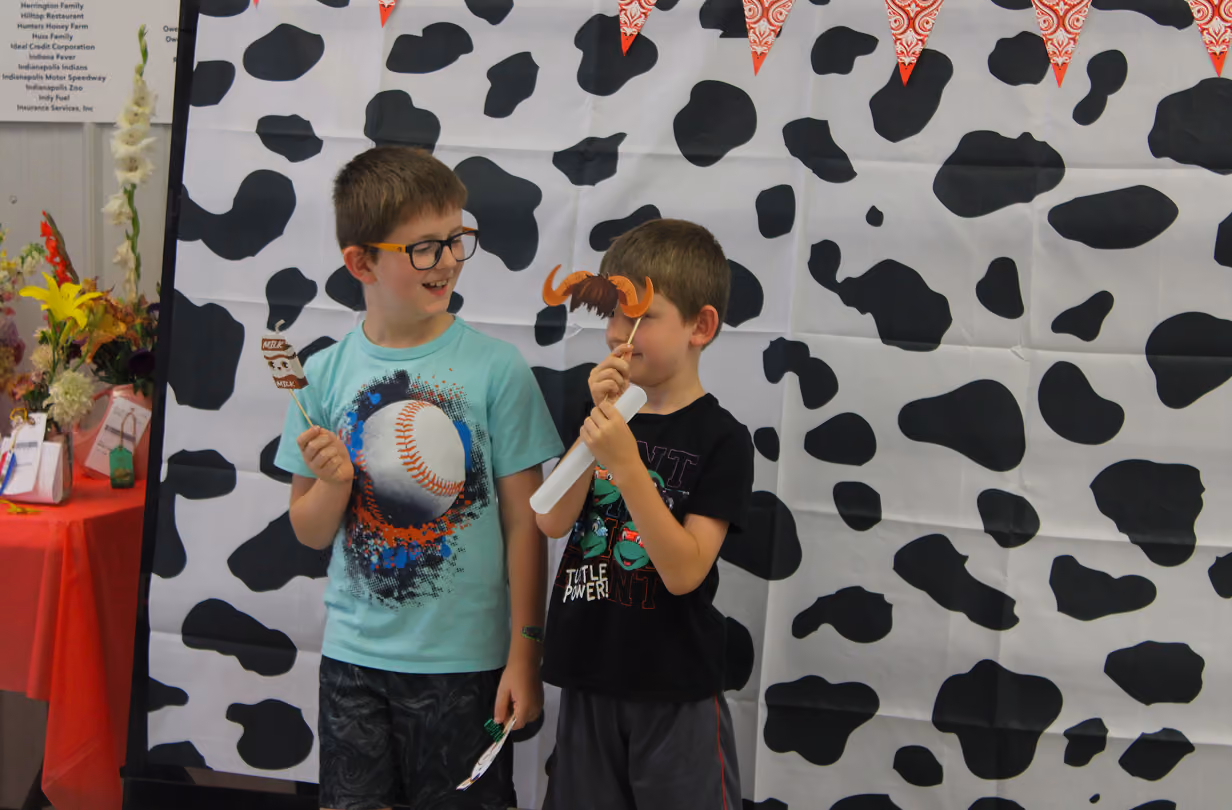 Winston and Barrett Zigler hold up props for a photo at the Book 2 Barn event on July 6, 2026, at the Owen County Fairgrounds.