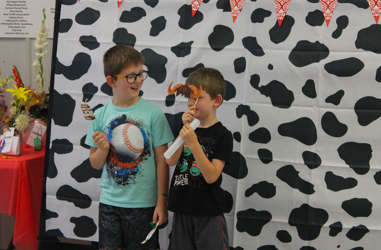 Winston and Barrett Zigler hold up props for a photo at the Book 2 Barn event on July 6, 2026, at the Owen County Fairgrounds.