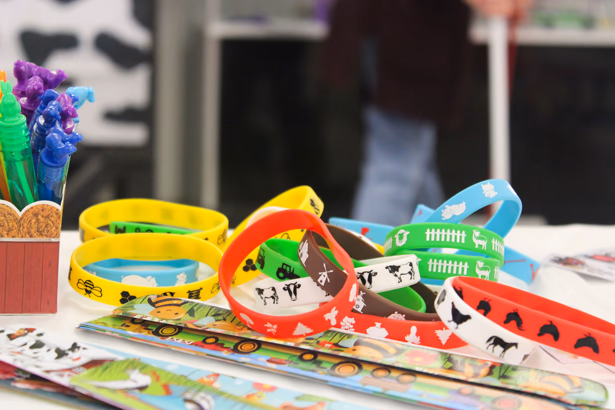 Rubber wristbands with farm animal designs lay on the table at the Book 2 Barn event on July 6, 2026, at the Owen County Fairgrounds.