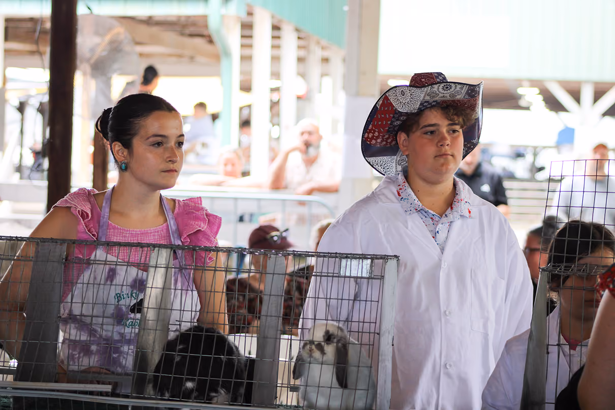 Ily Swan and Cash Weaver wait for judge Danielle Rowe to judge their rabbits on July 6 at the Owen County Fairgrounds. CHLOE ODEN | THE OWEN NEWS