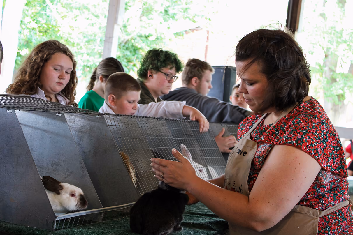 Judge Danielle Rowe assesses a rabbit during the 2026 Owen County Fair rabbit show on July 6 at the Owen County Fairgrounds. The entrants watched Rowe judge their projects. CHLOE ODEN | THE OWEN NEWS