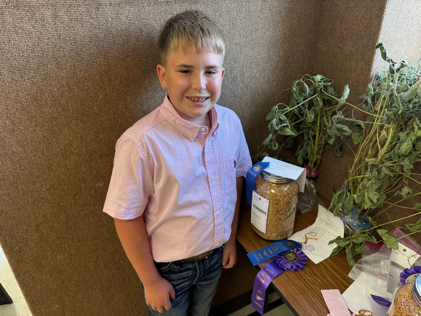 Soybeans Reserve Grand Champion Kale Dunning poses for a photo with his winning 4-H project. NICOLE DECRISCIO | THE OWEN NEWS