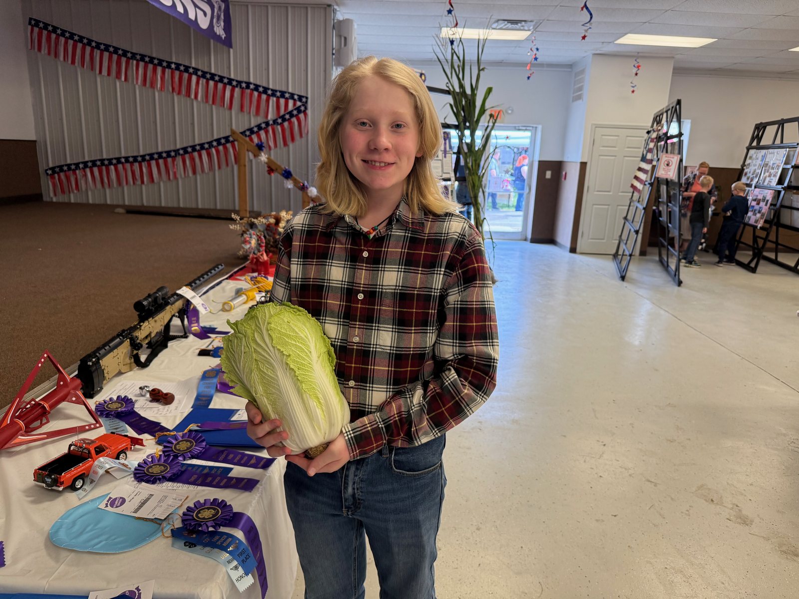 Chinese Cabbage Grand Champion Wyatt Curtis poses for a photo with the prize-winning Napa cabbage. NICOLE DECRISCIO | THE OWEN NEWS