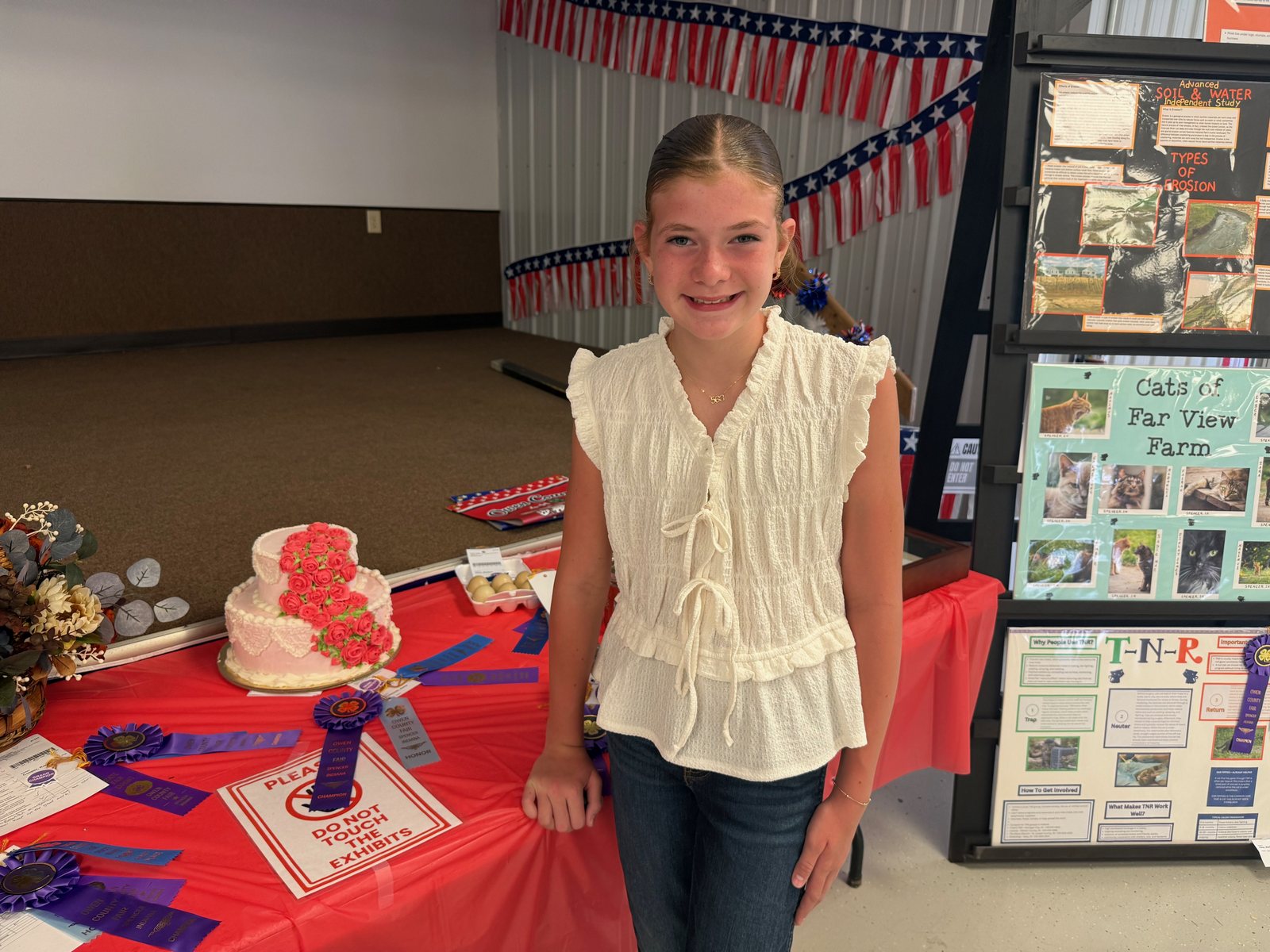 Alaina Staletovich, Reserve Champion, poses for a photo with her winning cake. NICOLE DECRISCIO | THE OWEN NEWS