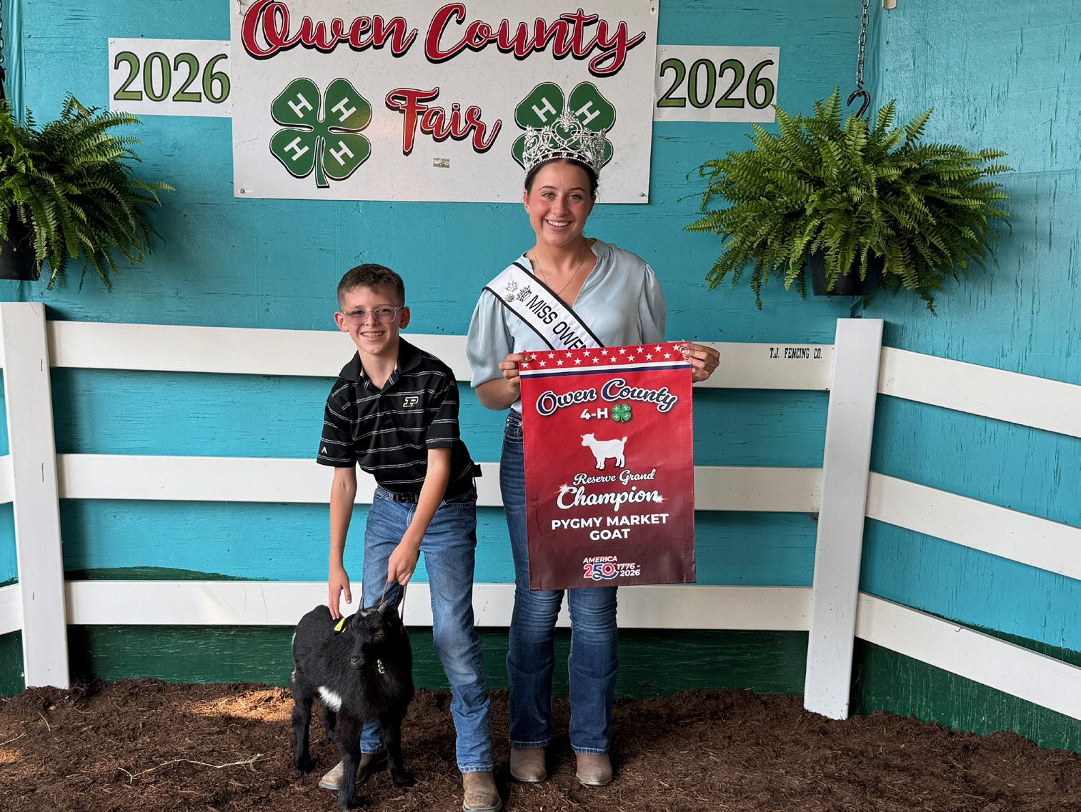 Oliver Smith is shown with Owen County Fair Queen Makayla Hall and his Reserve Grand Champion winning pygmy market goat at the 2026 Owen County Fair. NICOLE DECRISCIO | THE OWEN NEWS