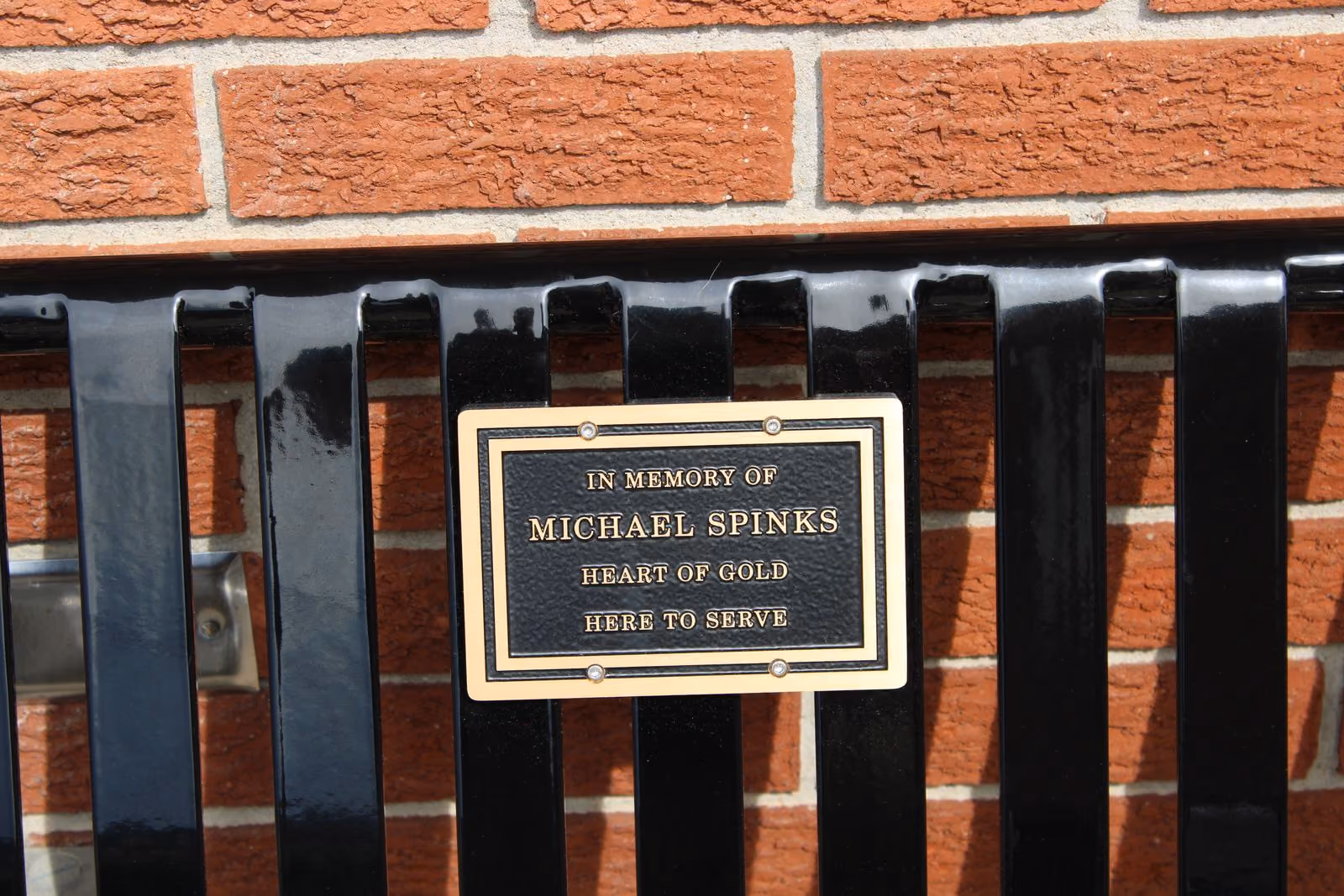 The plaque on the memorial bench: “In memory of Michael Spinks — Heart of gold — Here to serve.” TYLER DEFORD