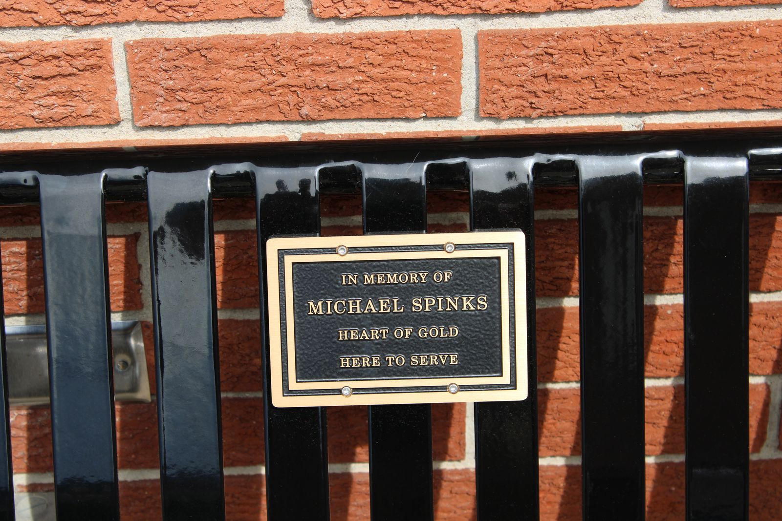 The plaque on the memorial bench: “In memory of Michael Spinks — Heart of gold — Here to serve.” TYLER DEFORD