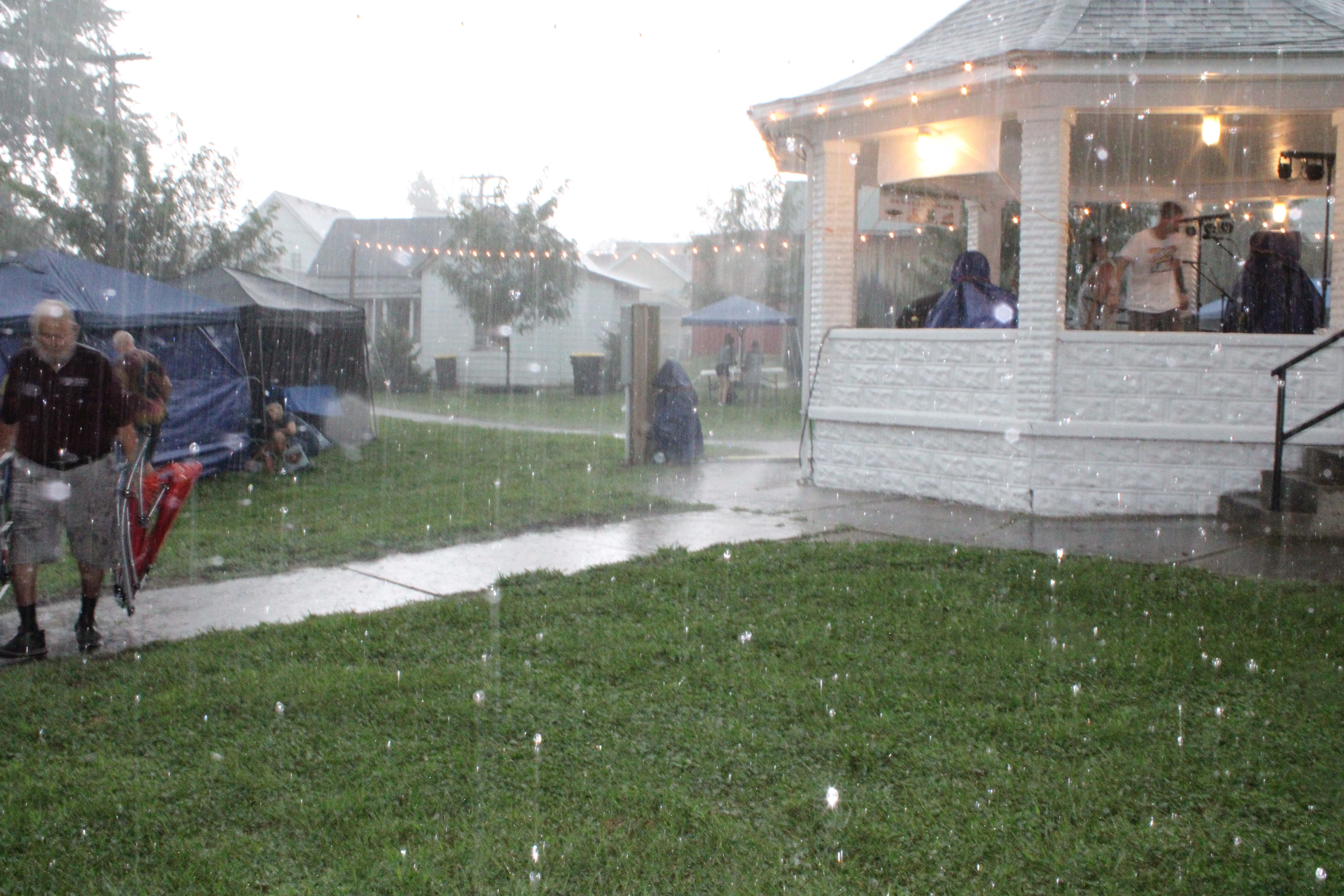Heavy rain drenches event-goers, Lazy Days volunteers and booth workers, delaying the opening ceremonies Thursday night. Photo By Tyler DeFord | The Owen News