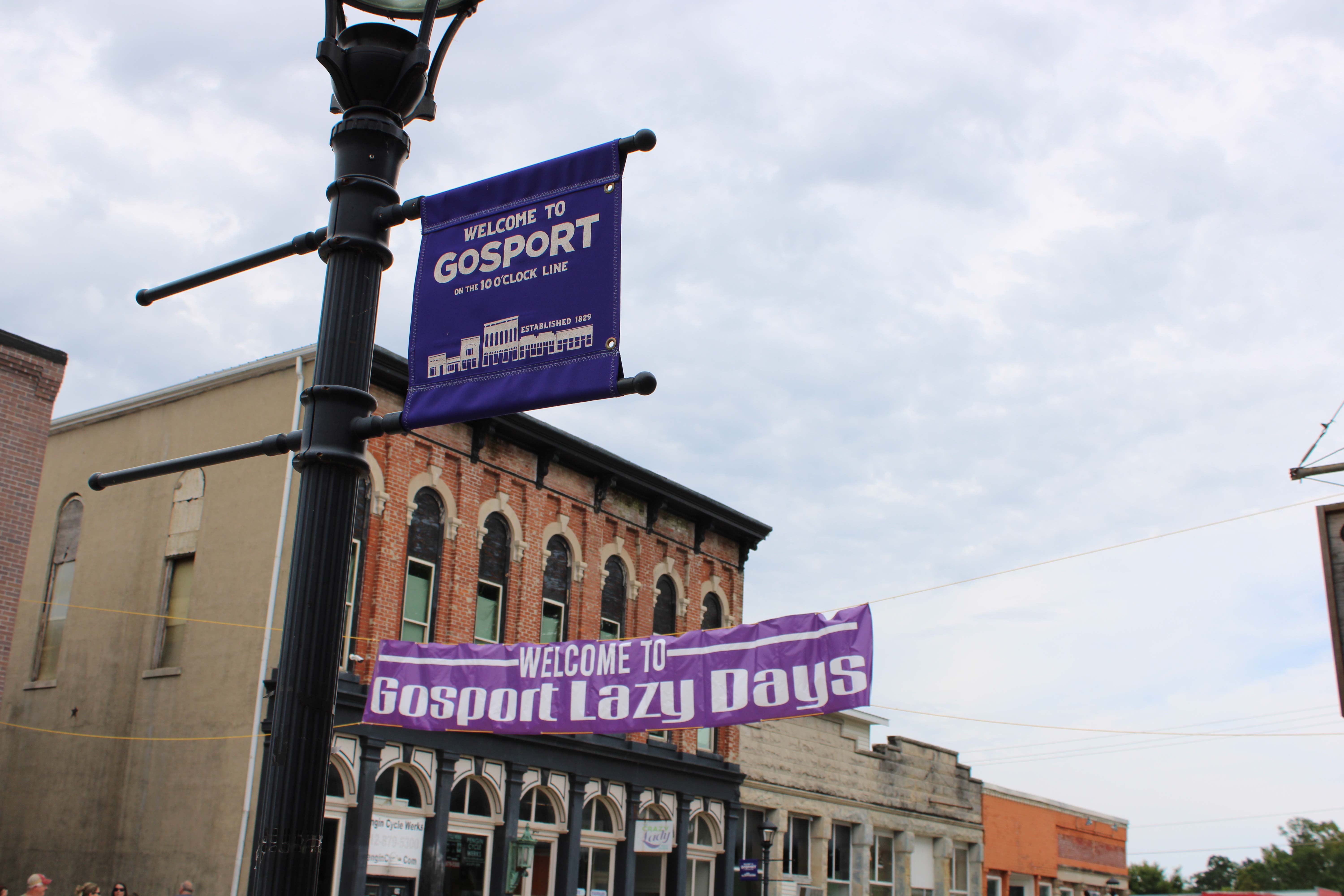 Two purple banners hang over Main Street in Gosport, one welcoming visitors to Gosport on the 10 oclock line, the other, welcoming visitors to Gosport Lazy Days. Photo by Tyler DeFord | The Owen News