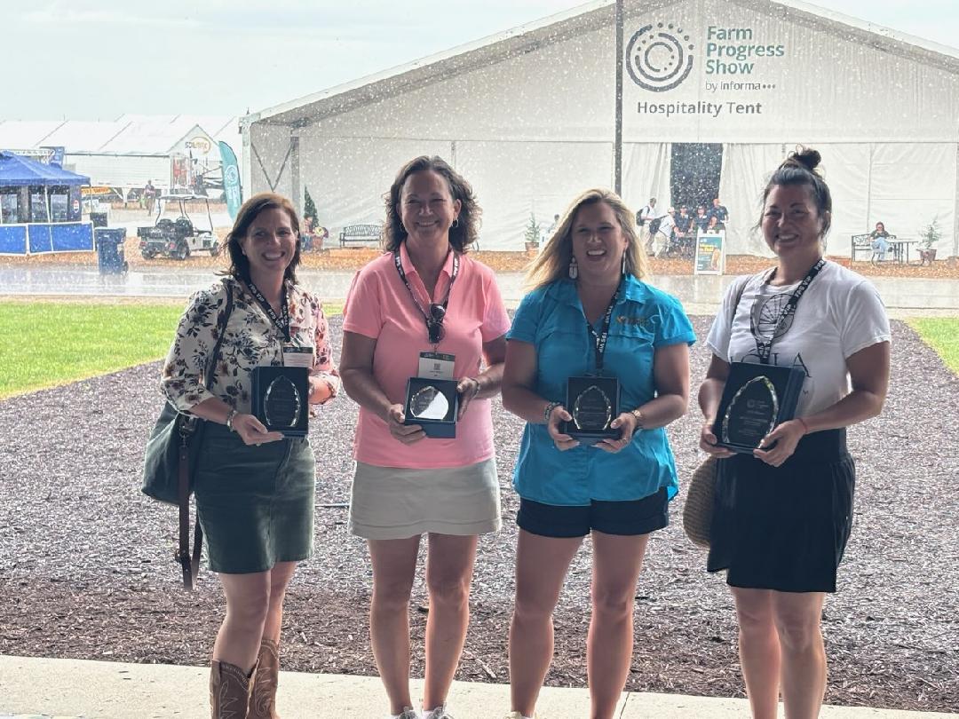 The four finalists for the Women in the Field award stand under cover with their awards. From left, Lisa Tate from California, Doris Scully, Karen Makomson from Mississippi and Wendy Johnson from Iowa. SUBMITTED PHOTO|DAVE SCULLY