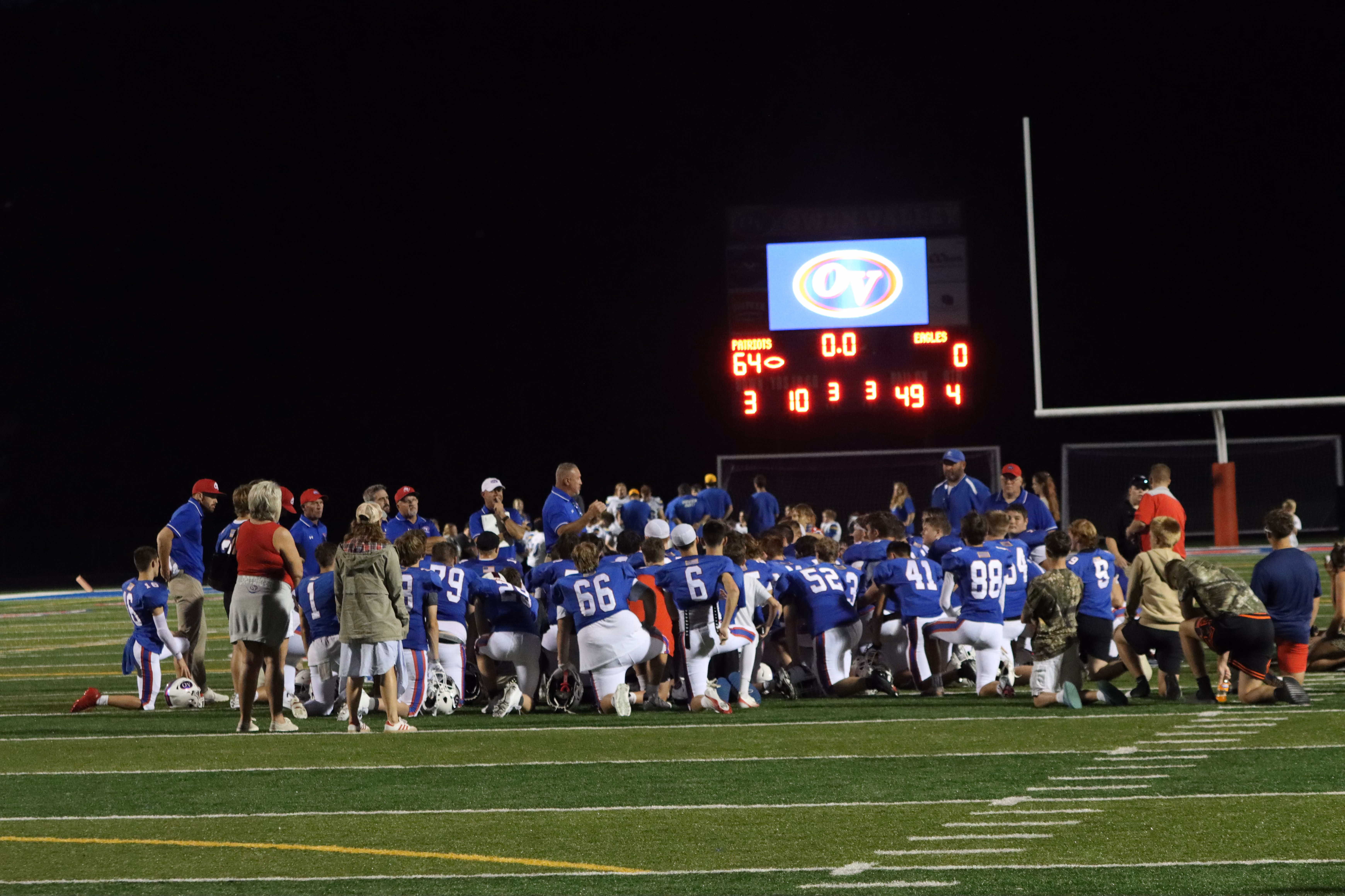The Patriots take a knee and listen to a post-game speech from head coach Troy Burgess. Burgess returns this year as Owen Valley’s head coach after a previous stint in the role from 1999-2001. SUBMITTED PHOTO | AARON LAGRANGE