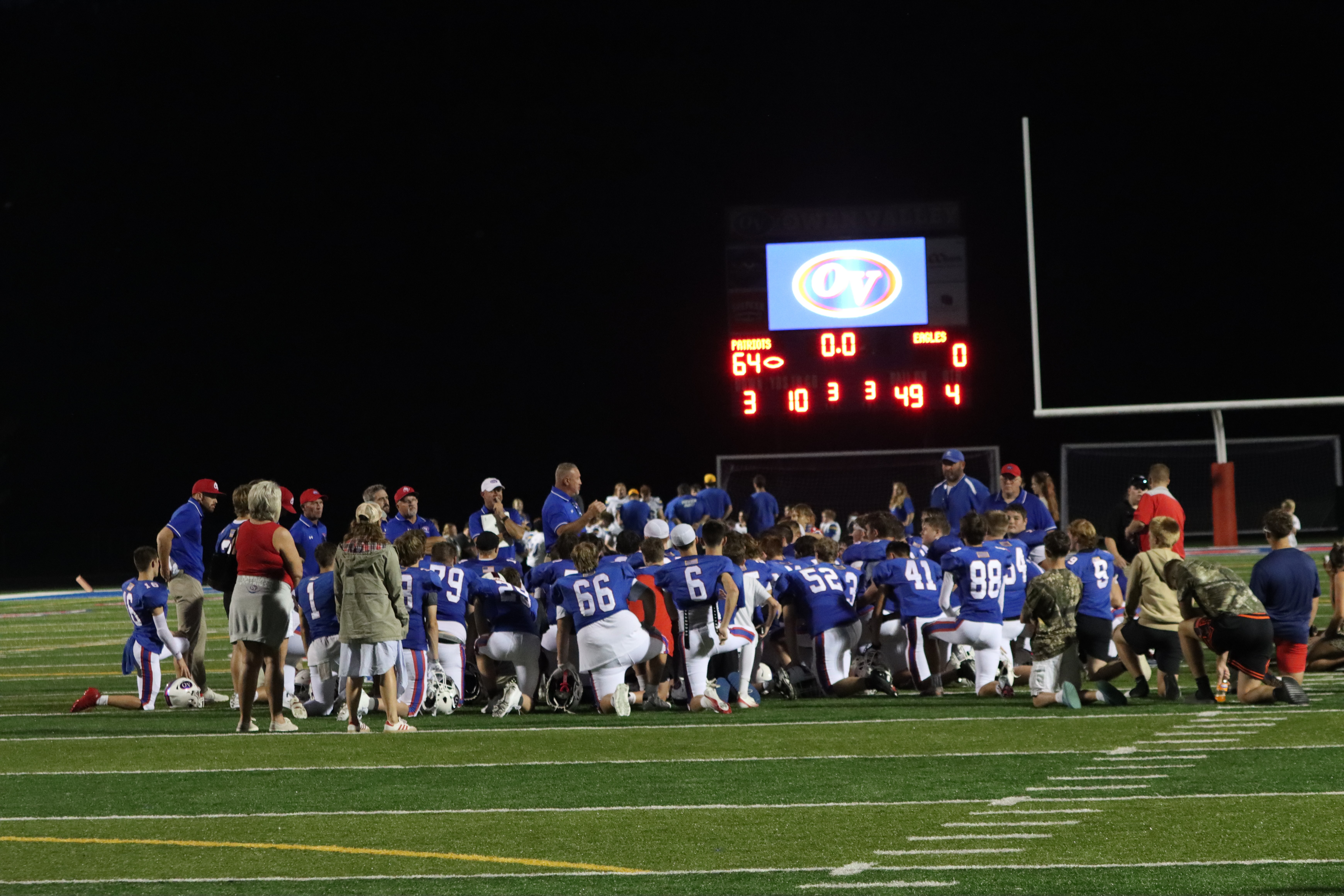 The Patriots take a knee and listen to a post-game speech from head coach Troy Burgess. Burgess returns this year as Owen Valley’s head coach after a previous stint in the role from 1999-2001. SUBMITTED PHOTO | AARON LAGRANGE