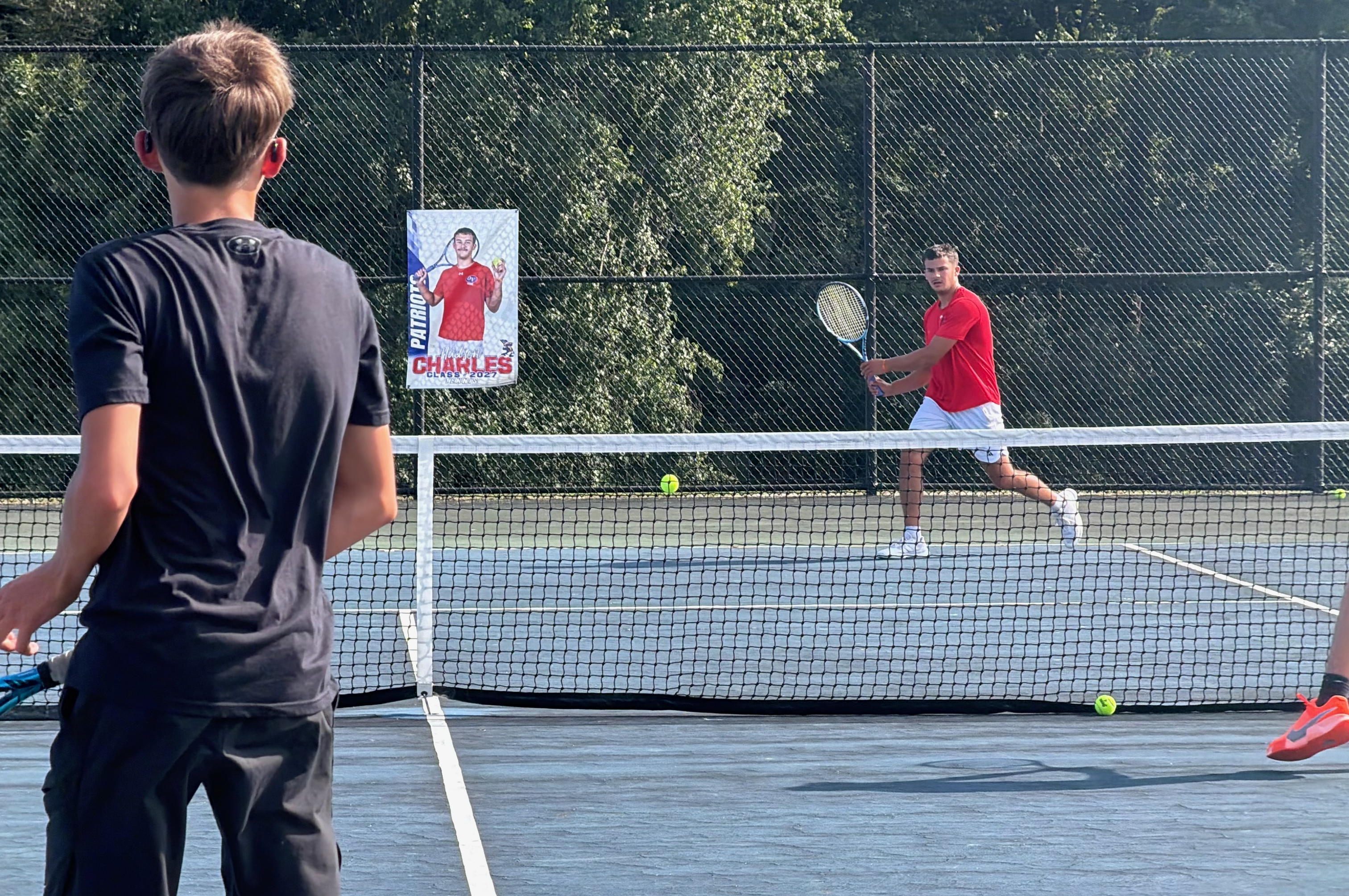 Owen Valley senior Hudson Charles returns a shot during a tough match against North Daviess. Charles competes on the Patriots’ No. 1 doubles team. STAFF PHOTO | THE OWEN NEWS