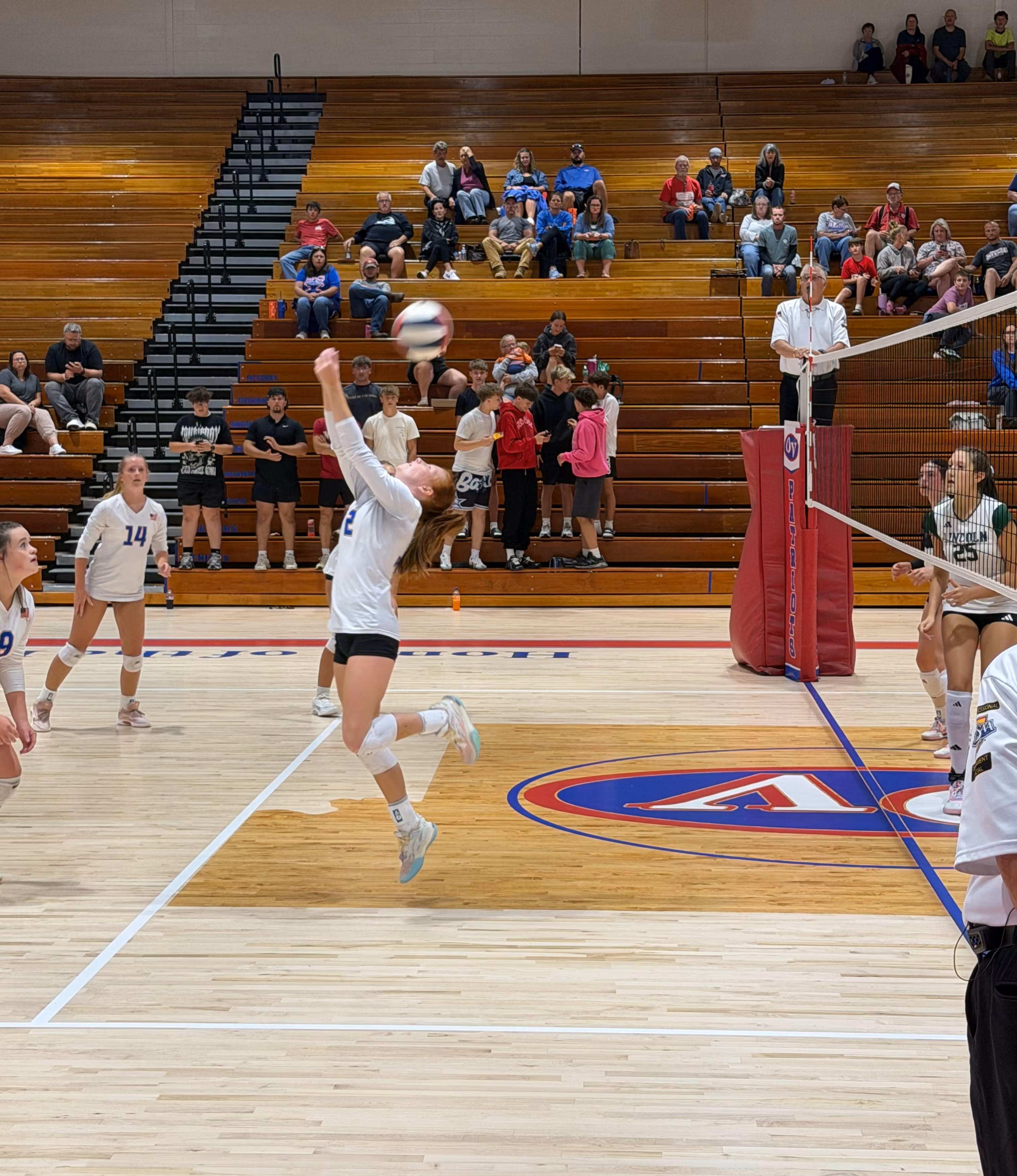 Patriots setter, senior Addy Applegate, demonstrates athleticism and perseverance with an unconventional reverse overhead bump. STAFF PHOTO | THE OWEN NEWS