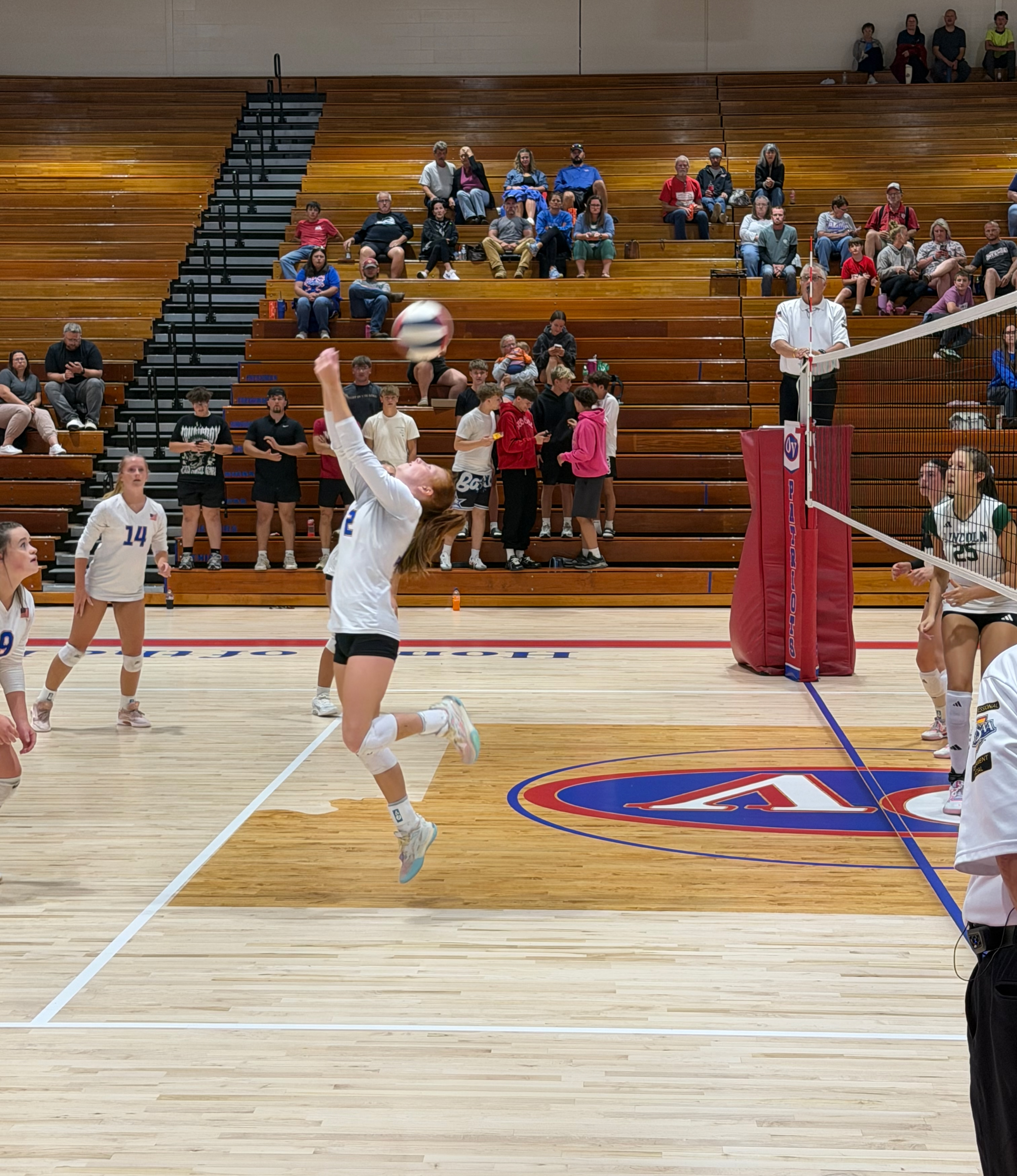 Patriots setter, senior Addy Applegate, demonstrates athleticism and perseverance with an unconventional reverse overhead bump. STAFF PHOTO | THE OWEN NEWS