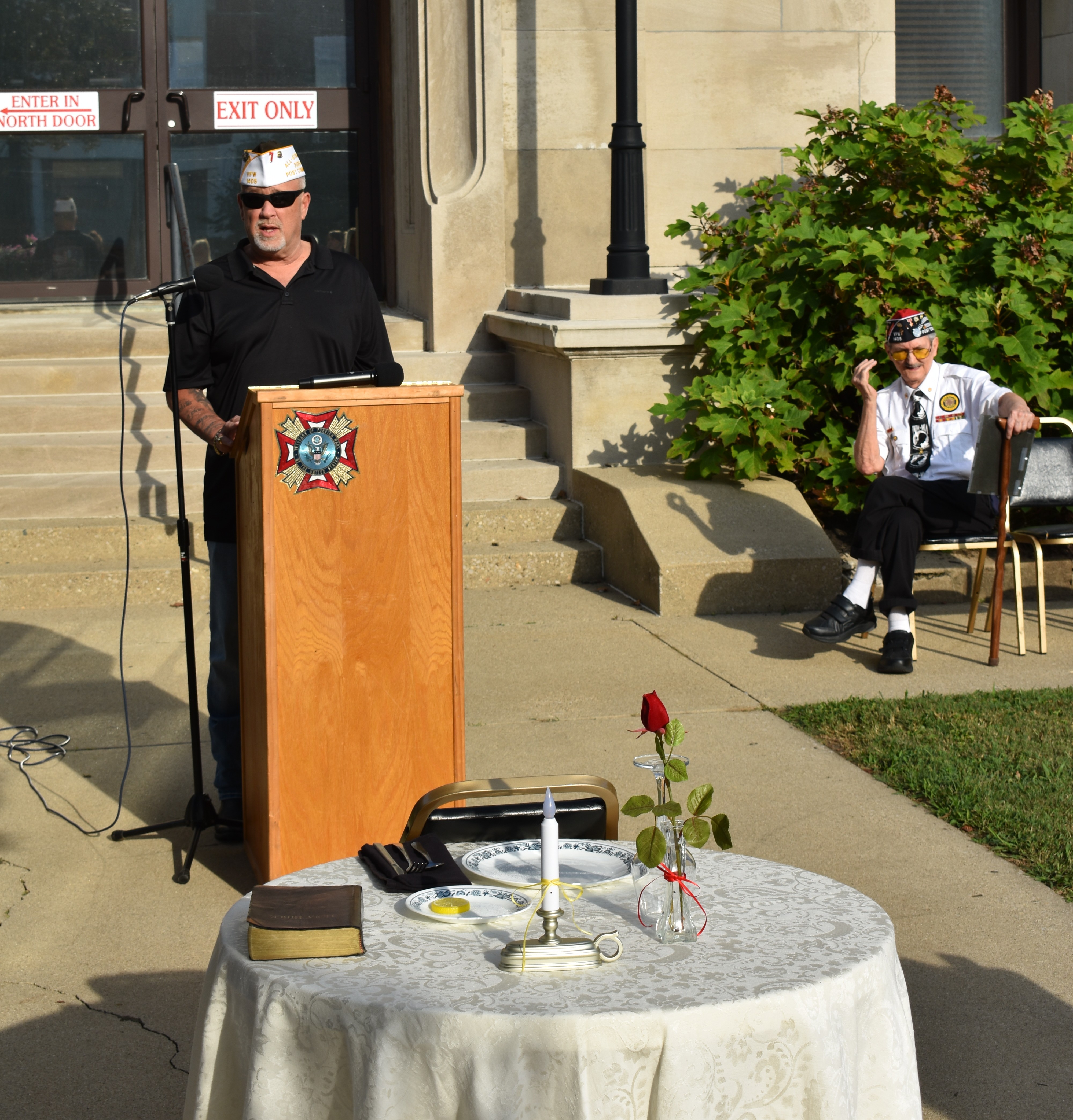 VFW Post #1405 Commander Brian Nash delivers the welcome address on the Owen County Courthouse lawn during the annual POW/MIA and 9/11 Remembrance Day ceremony, as Past Commander Ted Mangin looks on. TRAVIS CURRY | THE OWEN NEWS