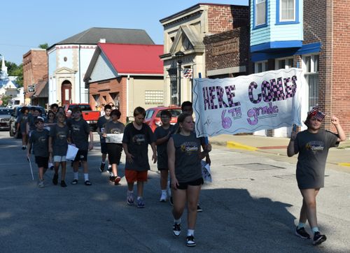 GES sixth graders march down the street carrying a banner reading "Here Comes the 6th Grade" during the annual back-to-school parade held Sept. 4 in Gosport. TRAVIS CURRY | THE OWEN NEWS