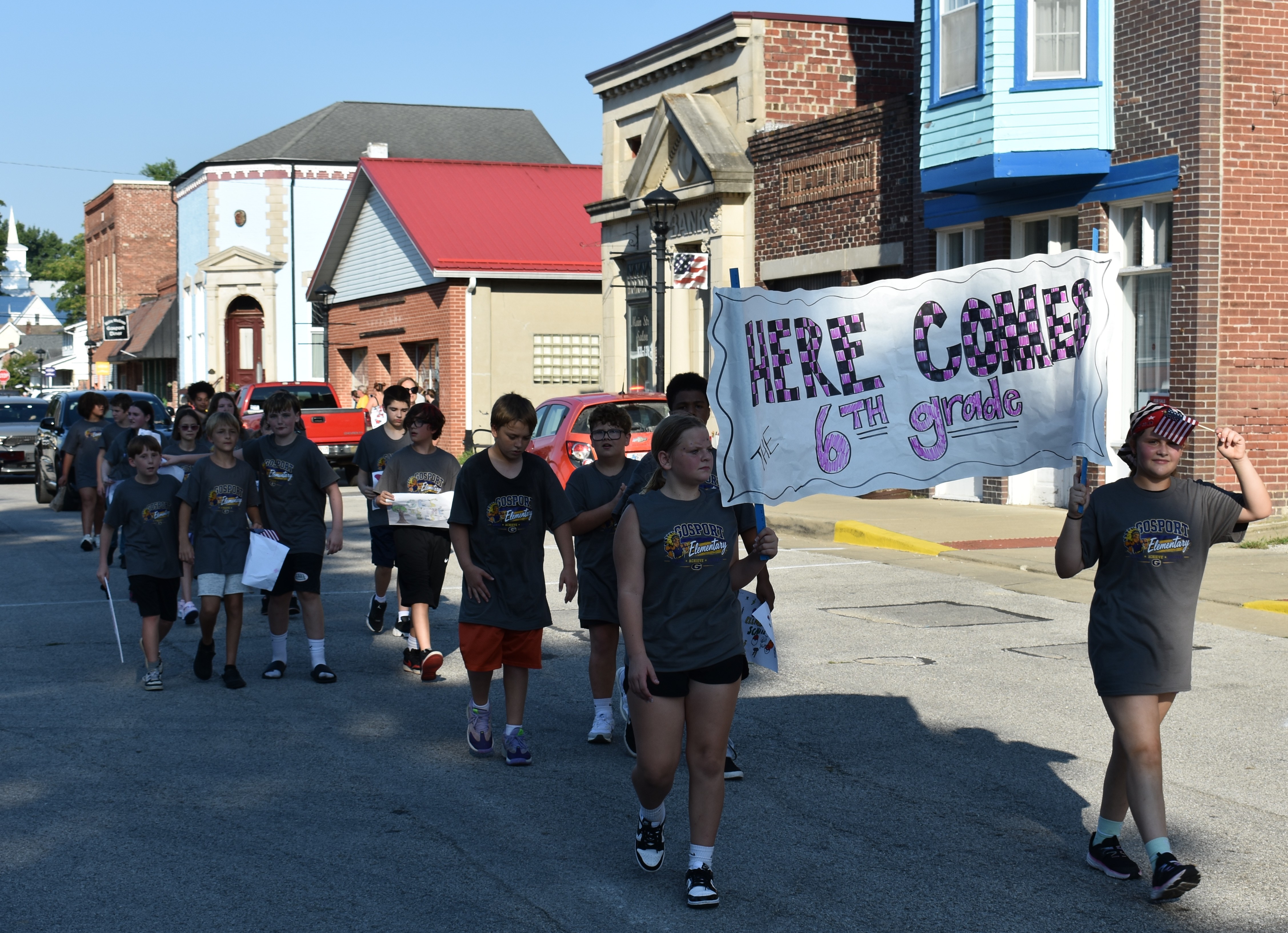 GES sixth graders march down the street carrying a banner reading "Here Comes the 6th Grade" during the annual back-to-school parade held Sept. 4 in Gosport. TRAVIS CURRY | THE OWEN NEWS