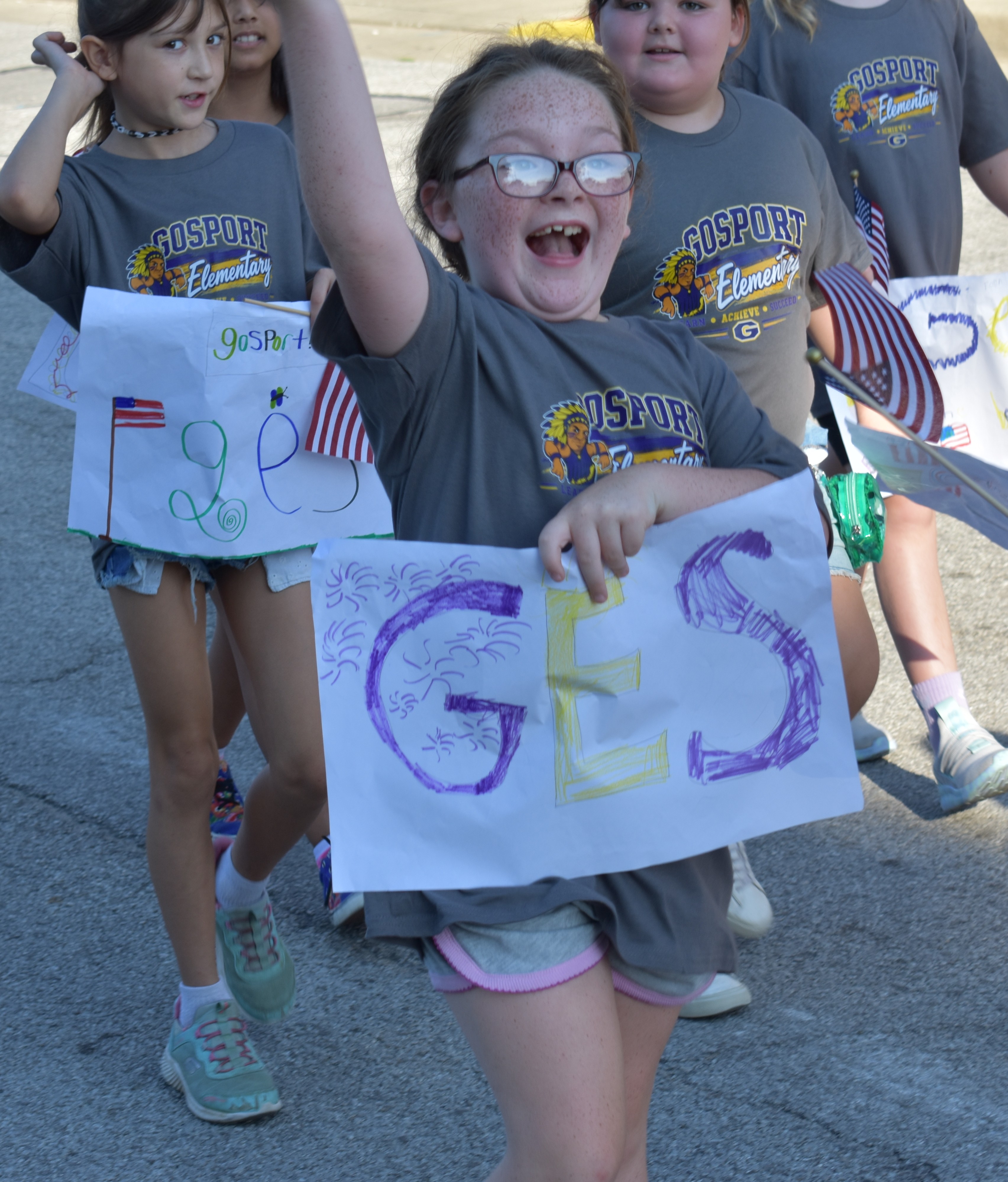 GES third grader Elly Leonard, daughter of Mike Leonard and Christine Summerlot, joyfully held up a handmade "GES" sign while marching in the annual back-to-school parade on Sept. 4. TRAVIS CURRY | THE OWEN NEWS