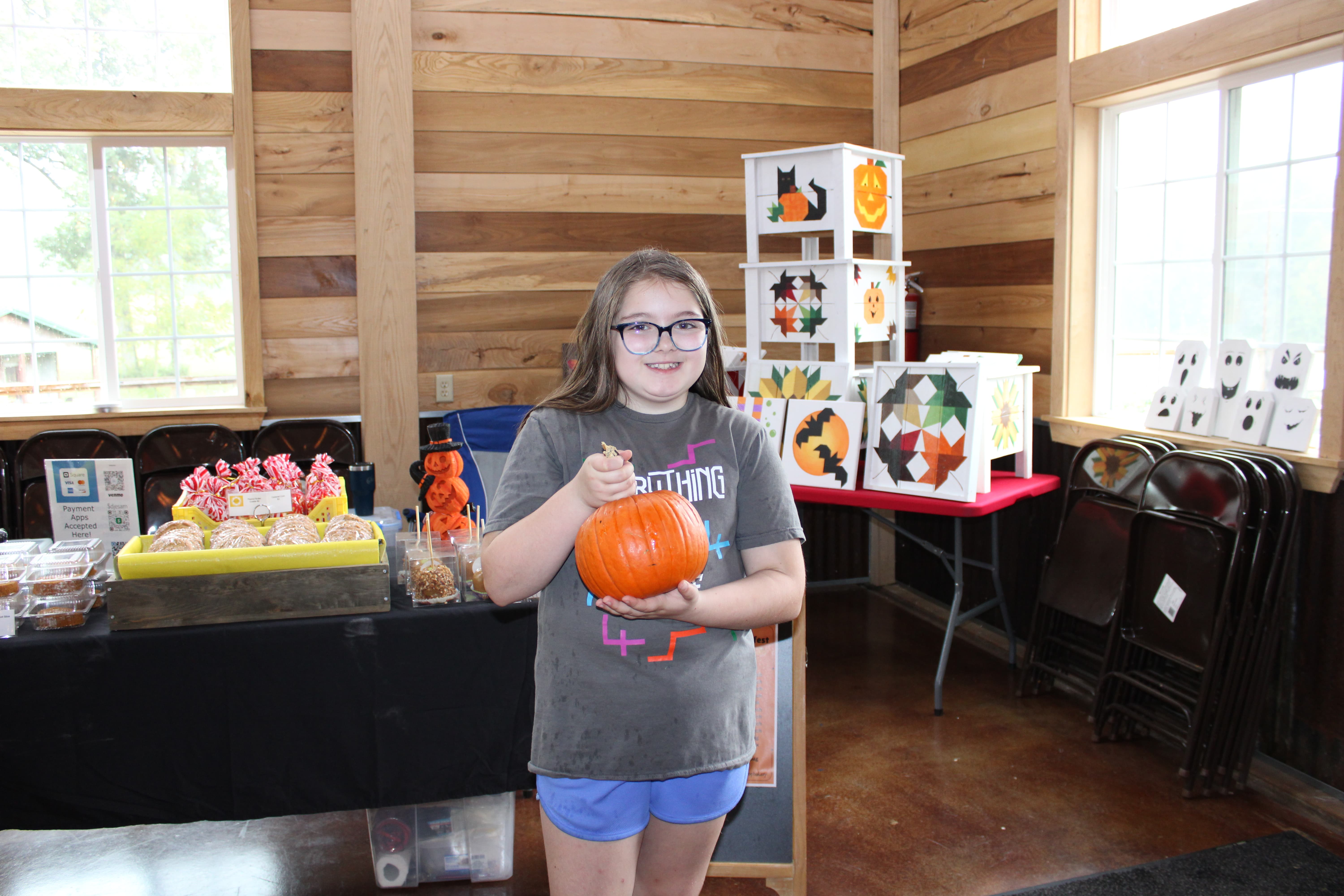 With hundreds of pumpkins to choose from at Harvest Moon Winery’s Pumpkinfest, Charlee Gentry shows off the one she selected to take home. STAFF PHOTO | THE OWEN NEWS
