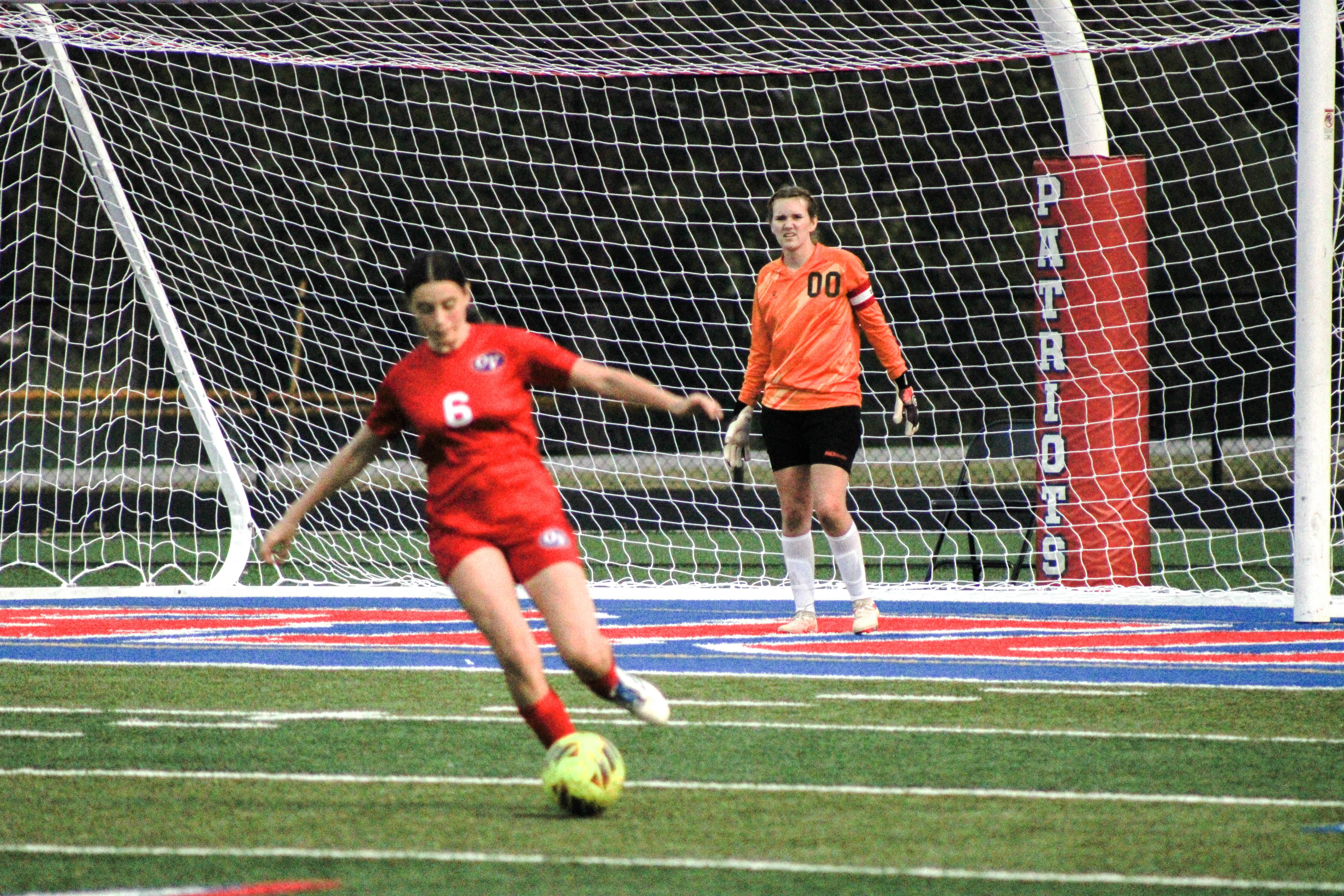 Freshman Makynlie Hall moves the ball upfield, giving goalie Jenny Brown a breather. STAFF PHOTO | THE OWEN NEWS