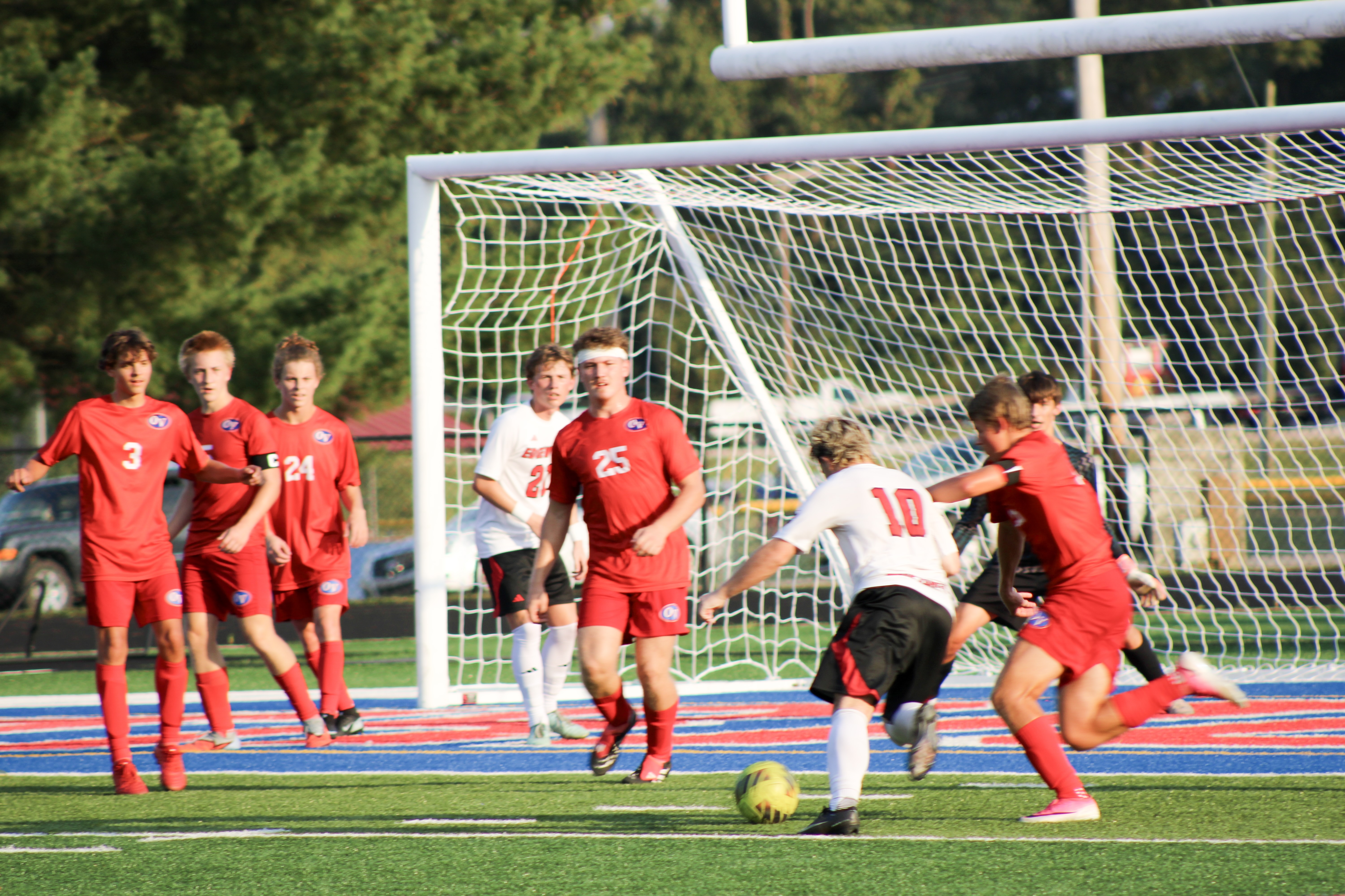 Patriots work together to get the ball out of the Mustang’s control. Despite a well-fought match, the Patriots fell to Edgewood 6-1. Patriots players from left: sophomore Jace Miller; senior  Ryan Padgett; senior Kayden Spencer; senior Gage Gregg; and senior Luke Deppe. STAFF PHOTO | THE OWEN NEWS