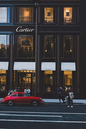 Cartier storefront with vintage red porsche parked outside