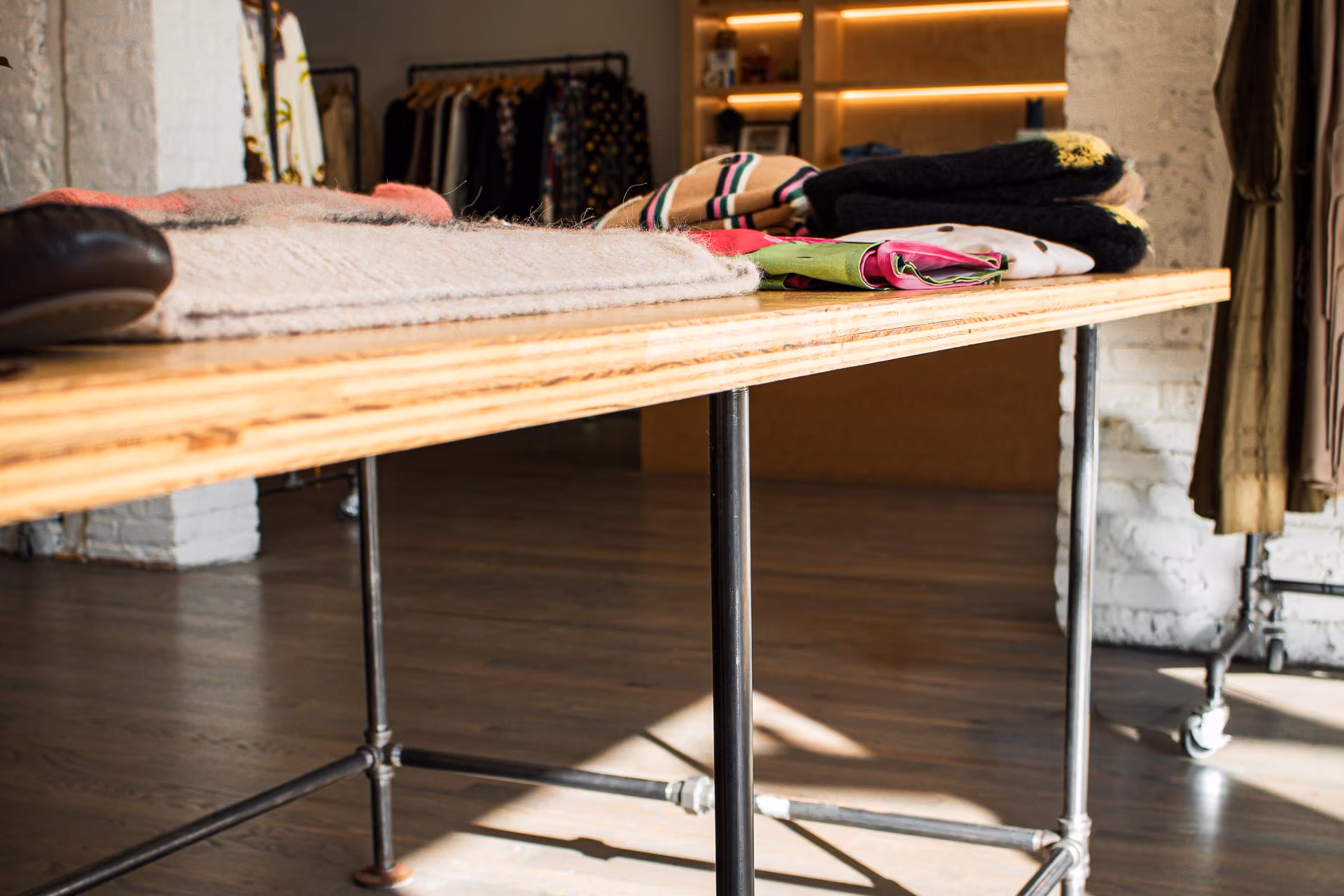 FELT Chicago wood and steel-pipe display table with folded knitwear