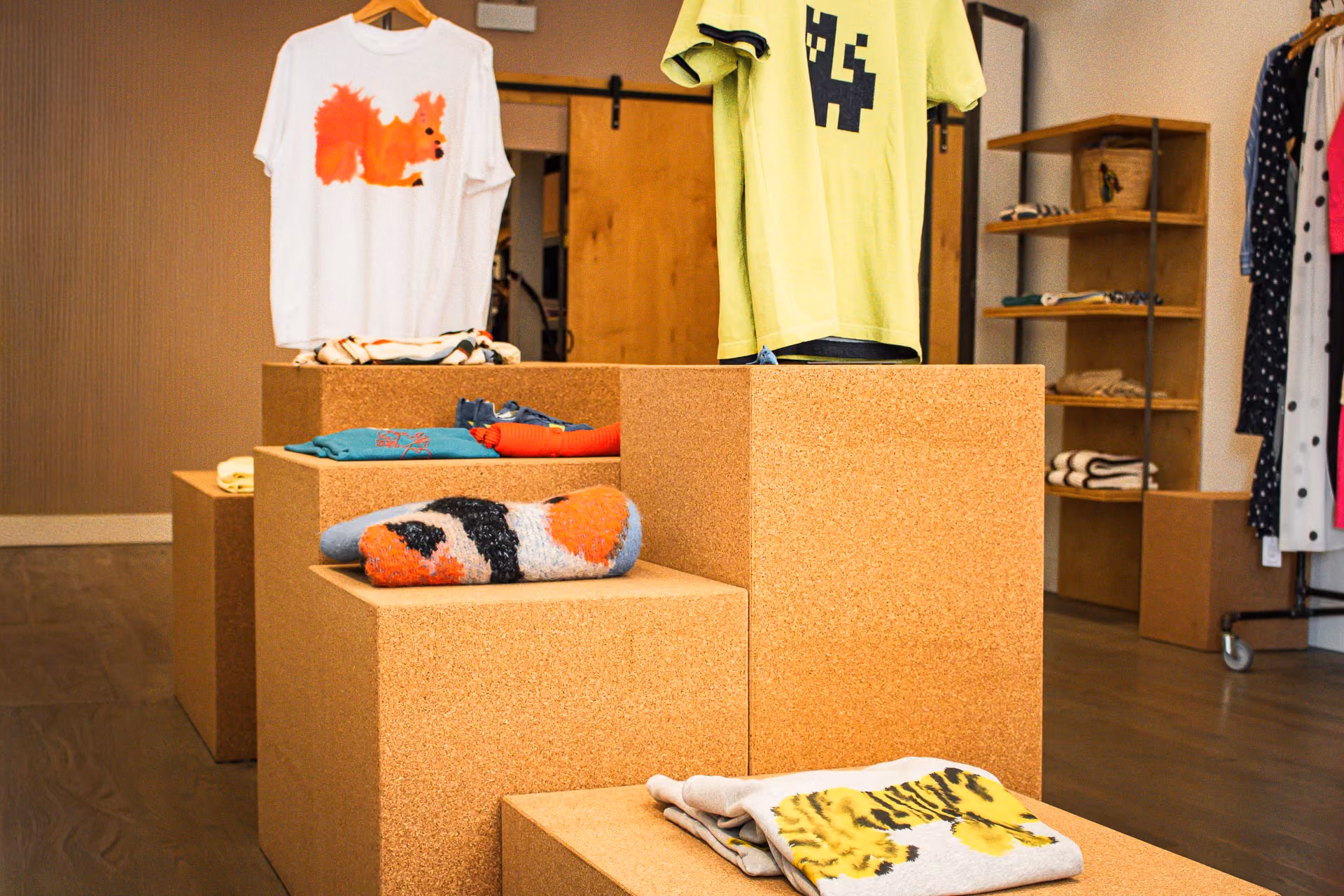 FELT Chicago cork display cubes with folded sweaters and t-shirts on hangers