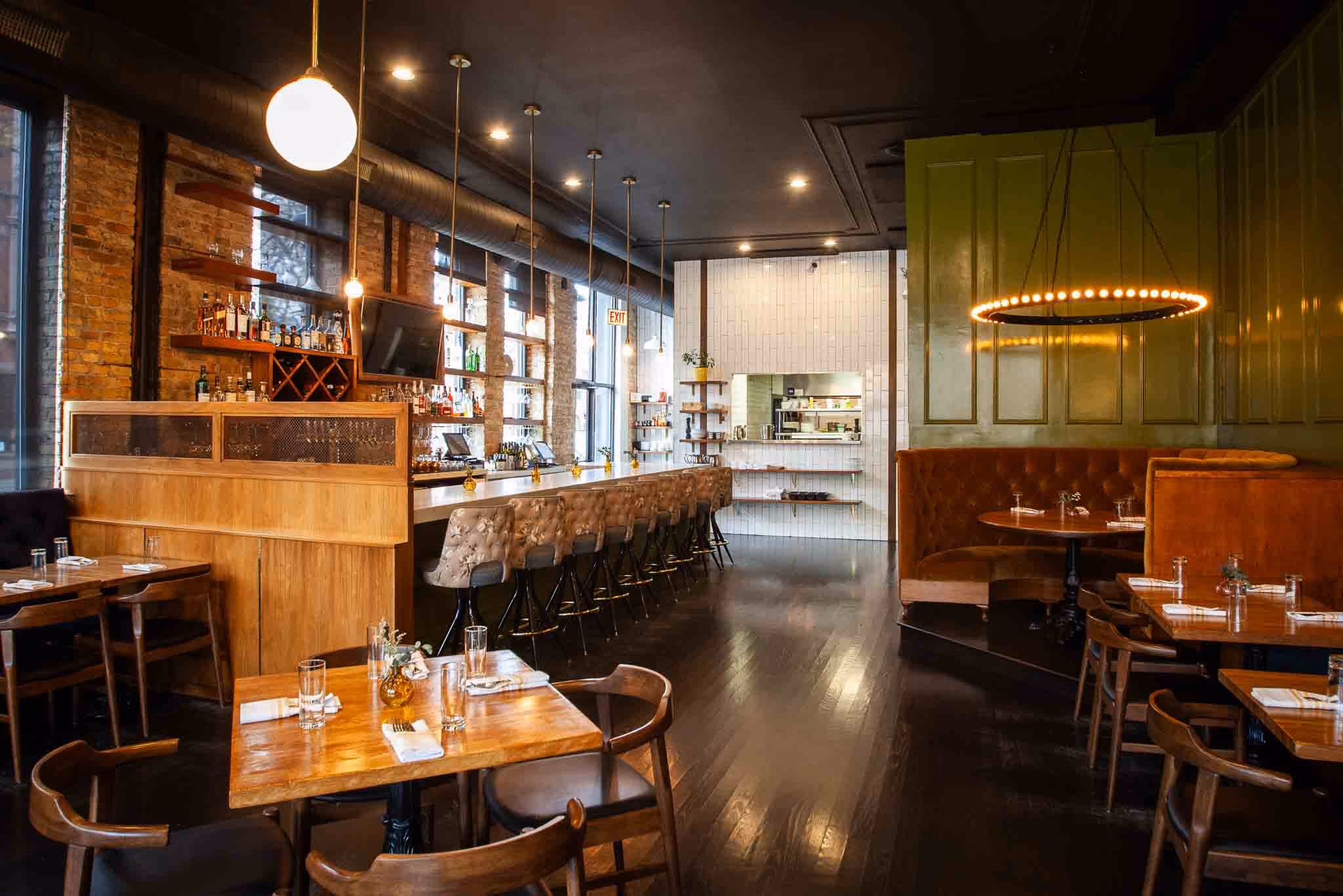 Willow Room dining room with globe pendant lights, exposed brick and wood tables