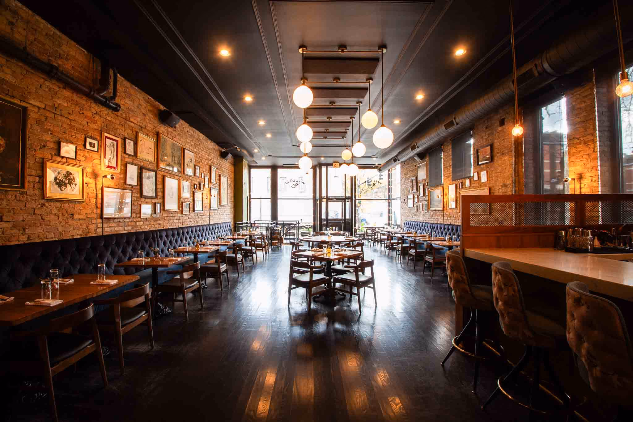 Willow Room long dining room with booths, framed art and a dark wood floor