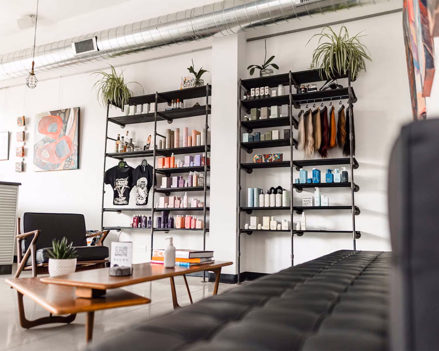 Rev. Billy's Chop Shop waiting area with a leather bench and product shelving