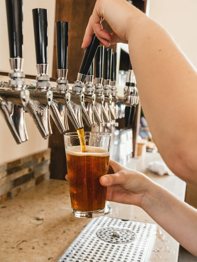 Barista pouring beer in a Glass