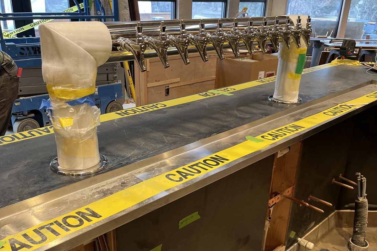 New stainless steel draft beer tower mid-installation at a Central Oregon bar