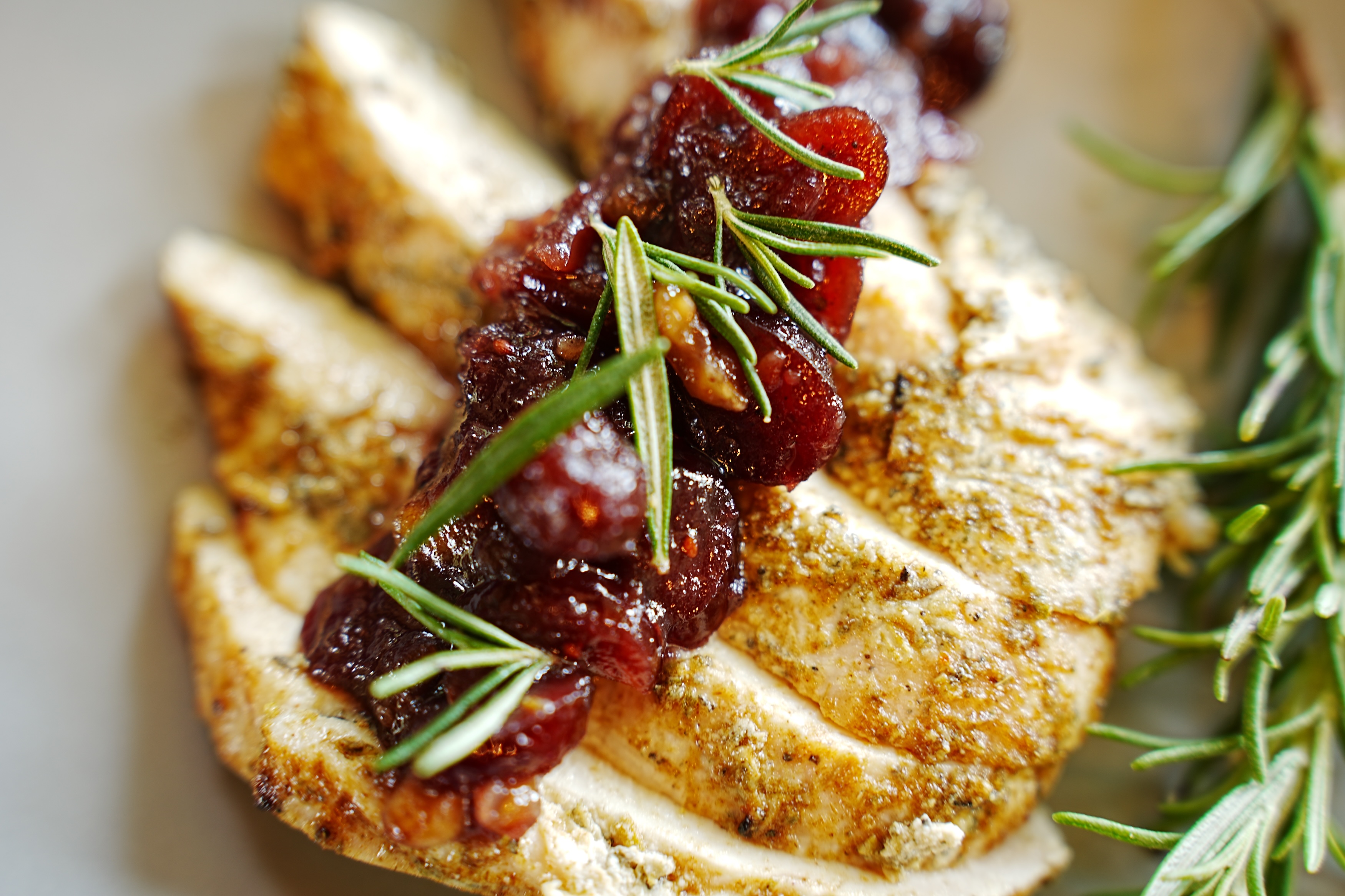 Holiday roast with cranberry garnish and rosemary