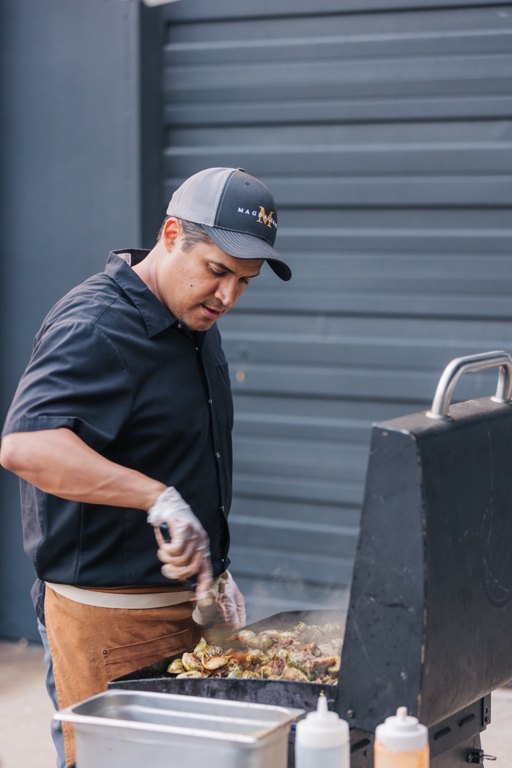 Chef Juan Rodriguez preparing food at an outdoor grill