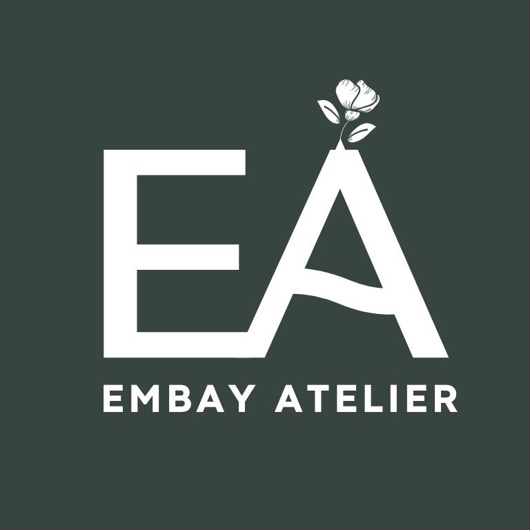 EMBAY ATELIER logo with stylized white letters EA on dark green background and a small flower growing from the letter A.