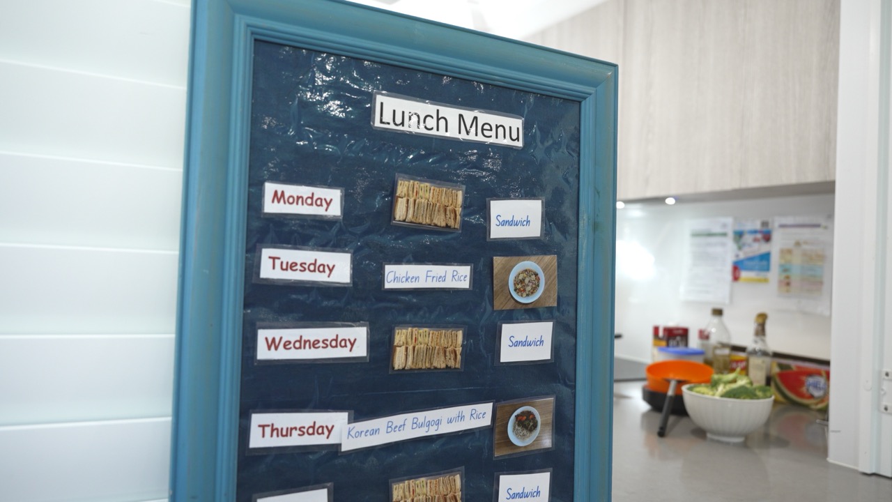 Weekly lunch menu board beside the preschool kitchen
