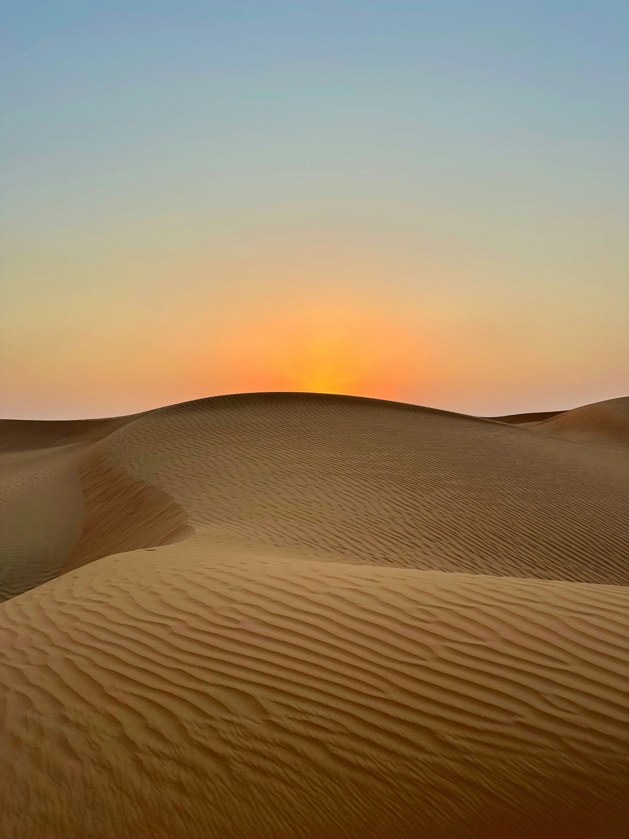 Sun setting over desert dunes in Ras Al Khaimah