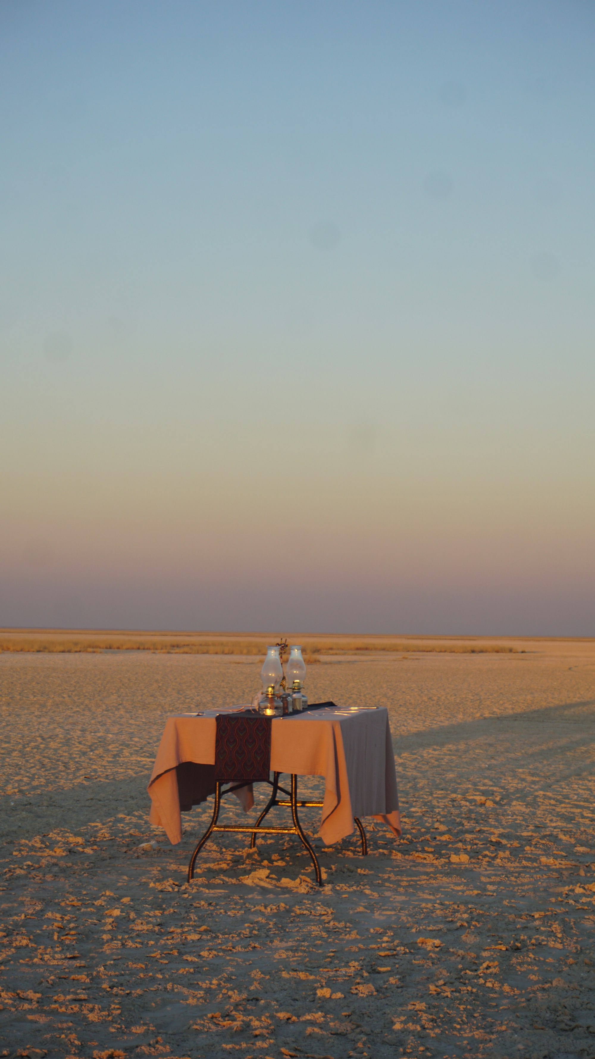 Table set for two in the desert at sunset