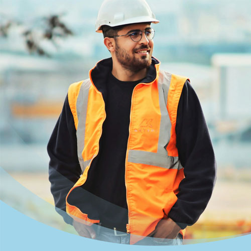 A man wearing a hardhat and high visibility vest