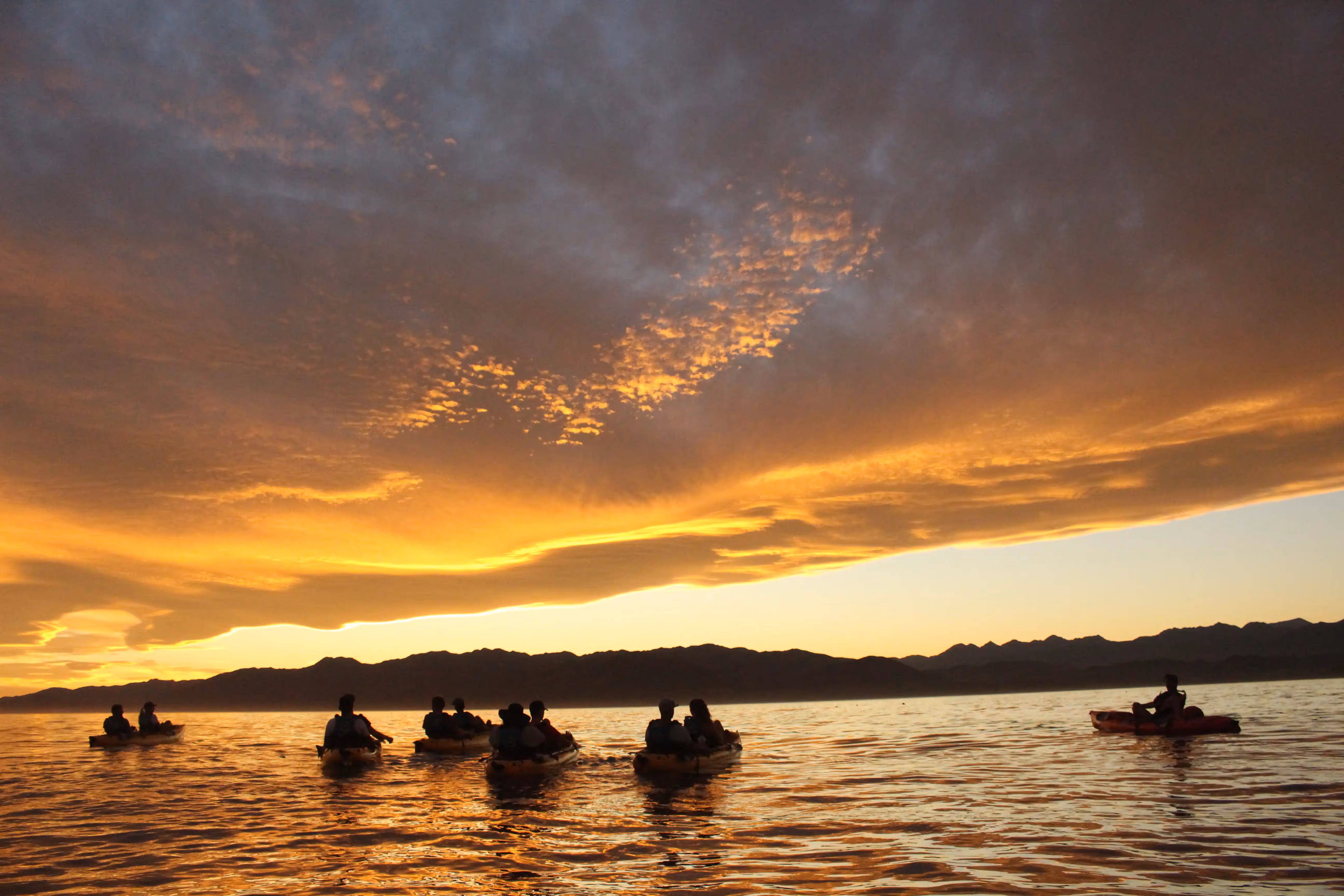 Kayaks on the water at sunset