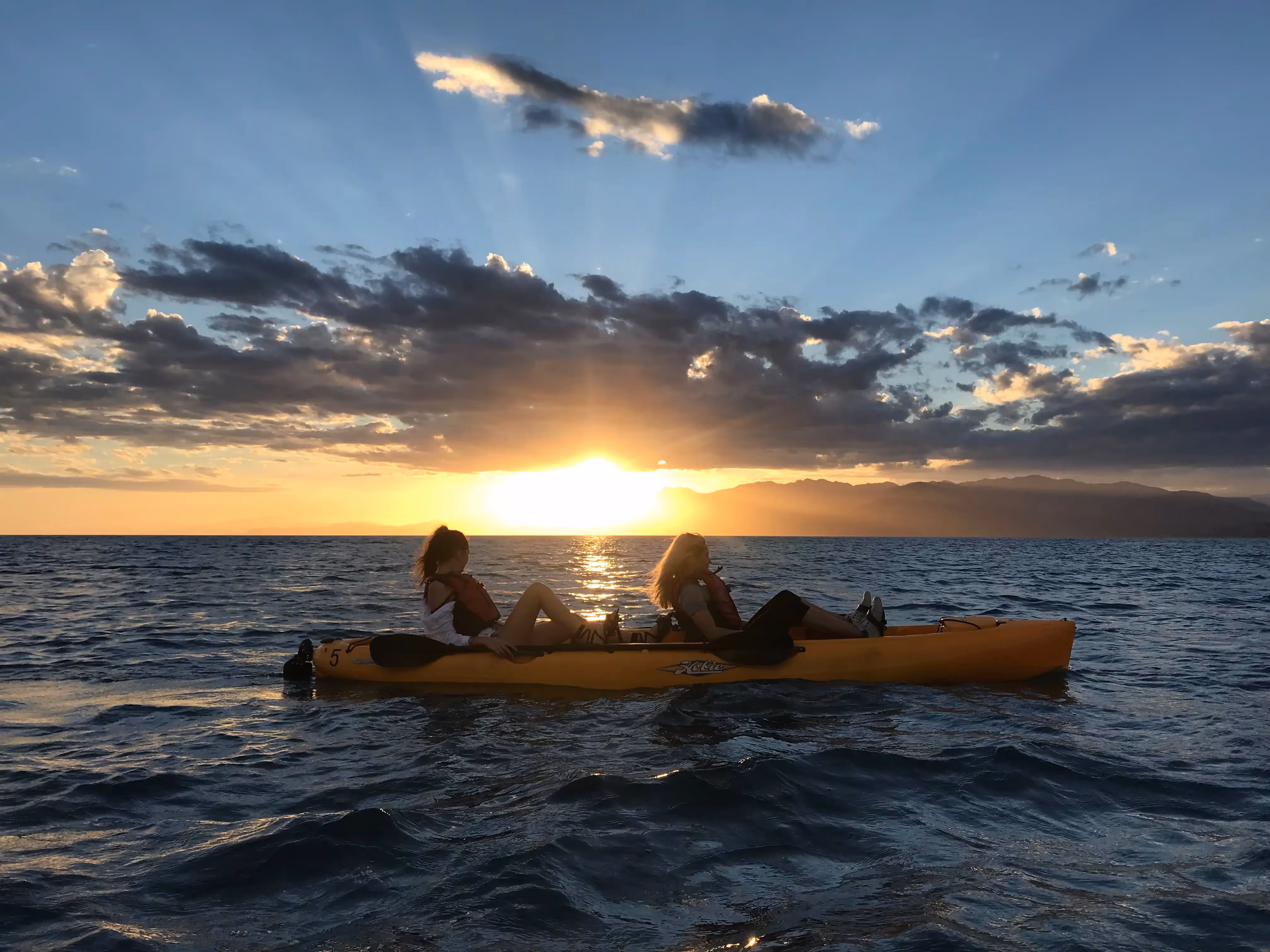 Kayaks on the water at sunset